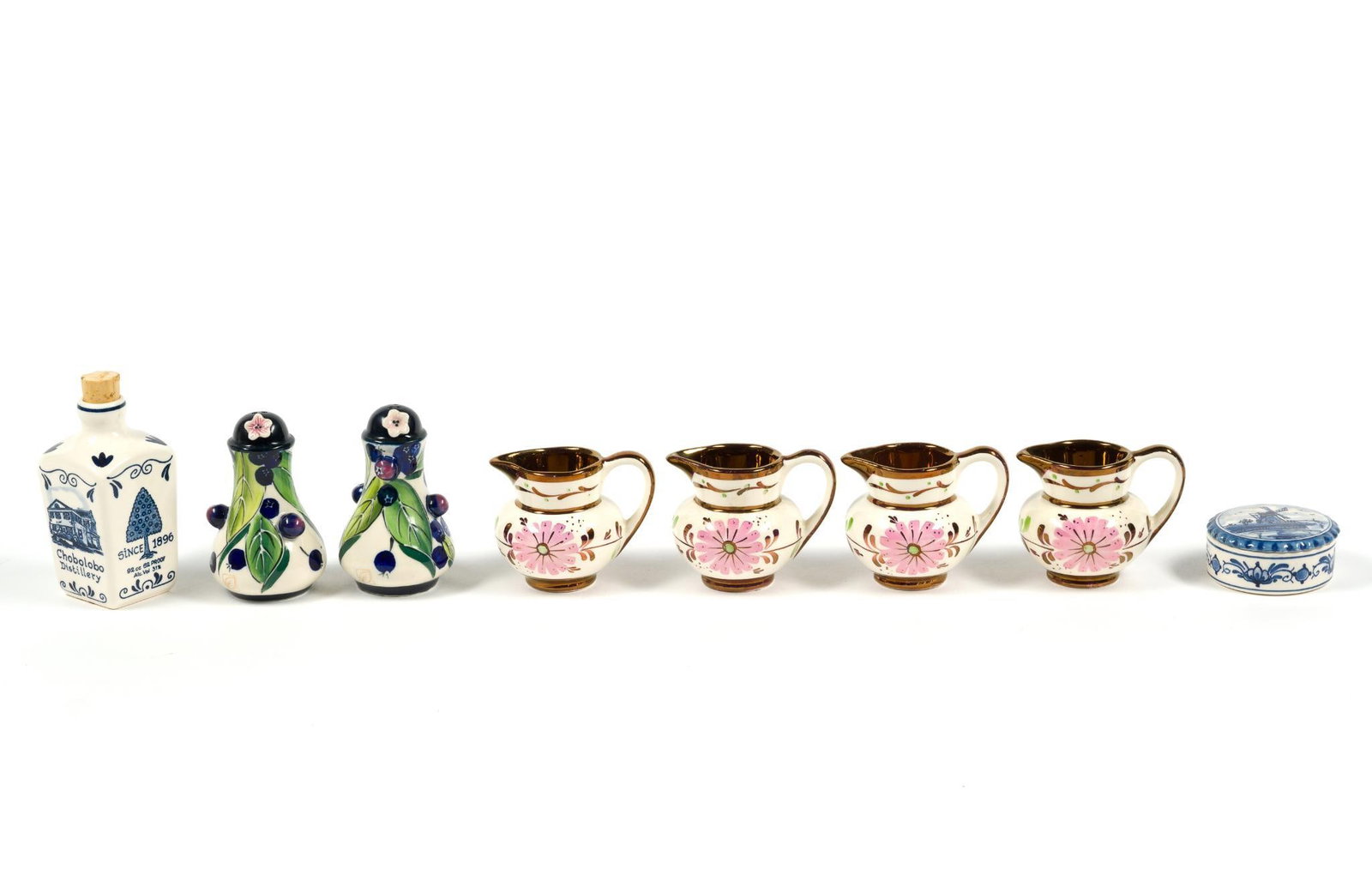 8 Miniature Porcelain Pieces Incl. Delft: 4 Old Castle Creamer Jugs, 2 J. McCall Blue Sky Salt & Pepper Shakers, a Delf trinket box and a blue Delft Curacao Liquer bottle, which measures 2" x 4 - 1/2" x 2".