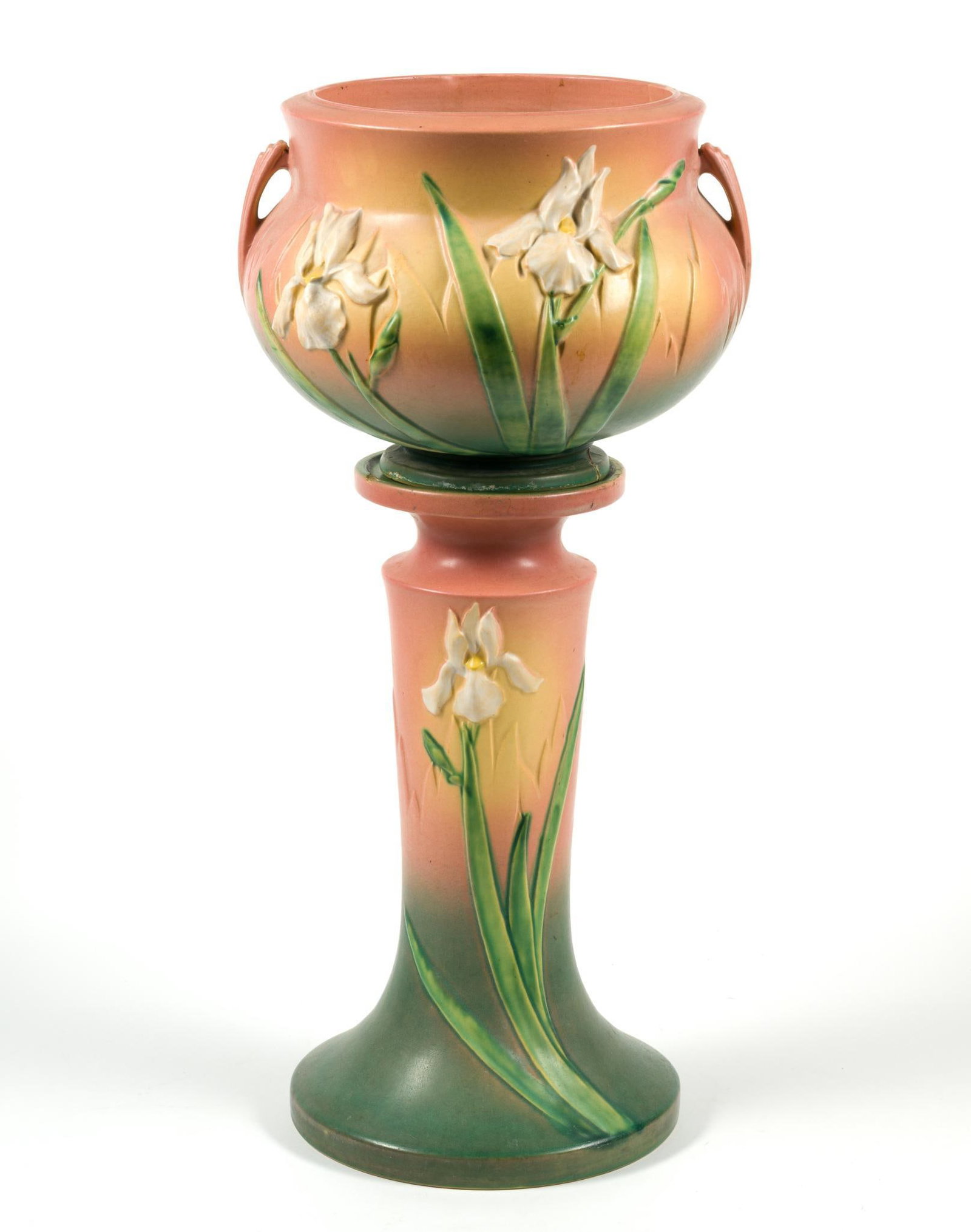 Roseville Pink Iris Jardinière & Pedestal: Small chip out of the top of the pedestal, and the base of the jardiniere has some cracking and has been repaired but not visible. Measures 12" across and 25 - 1/2" tall when the planter is on the