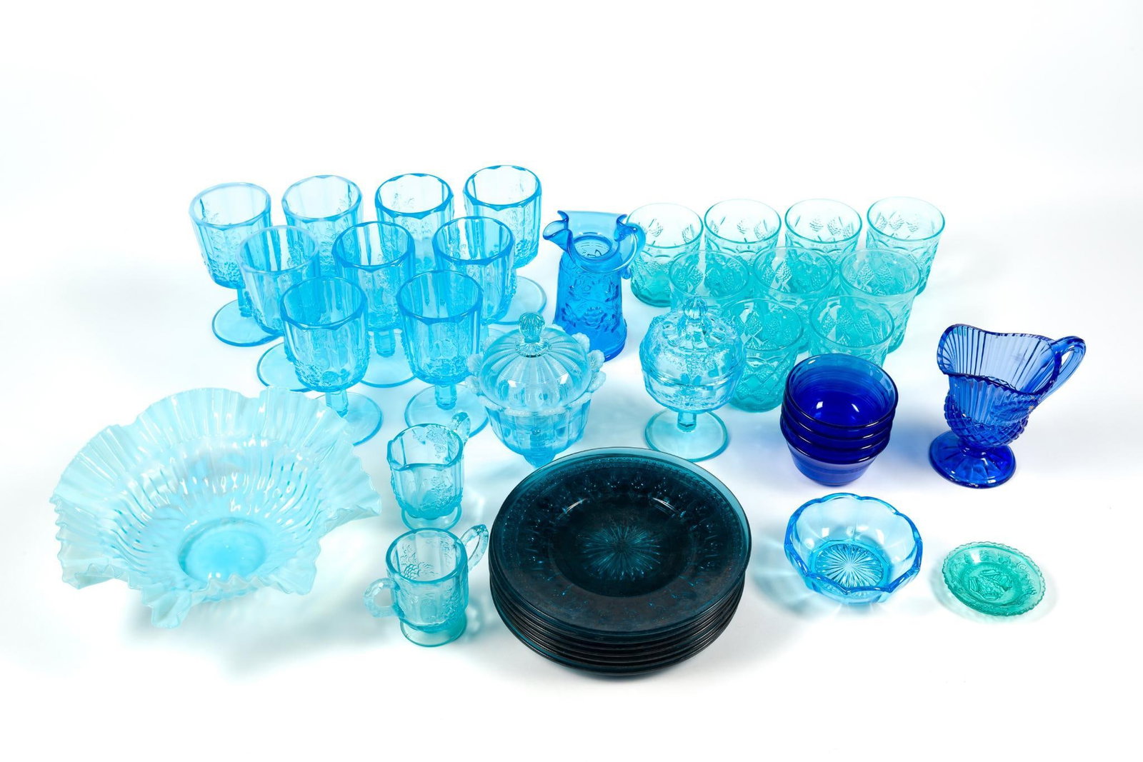 Vintage Blue Glass Incl. Pyrex: 2 sets of cups, a set of blue glass plates, vases, bowls, etc. Largest piece measures 11" x 11" x 4" and the small pyrex bowls measure 4" x 2" x 4".