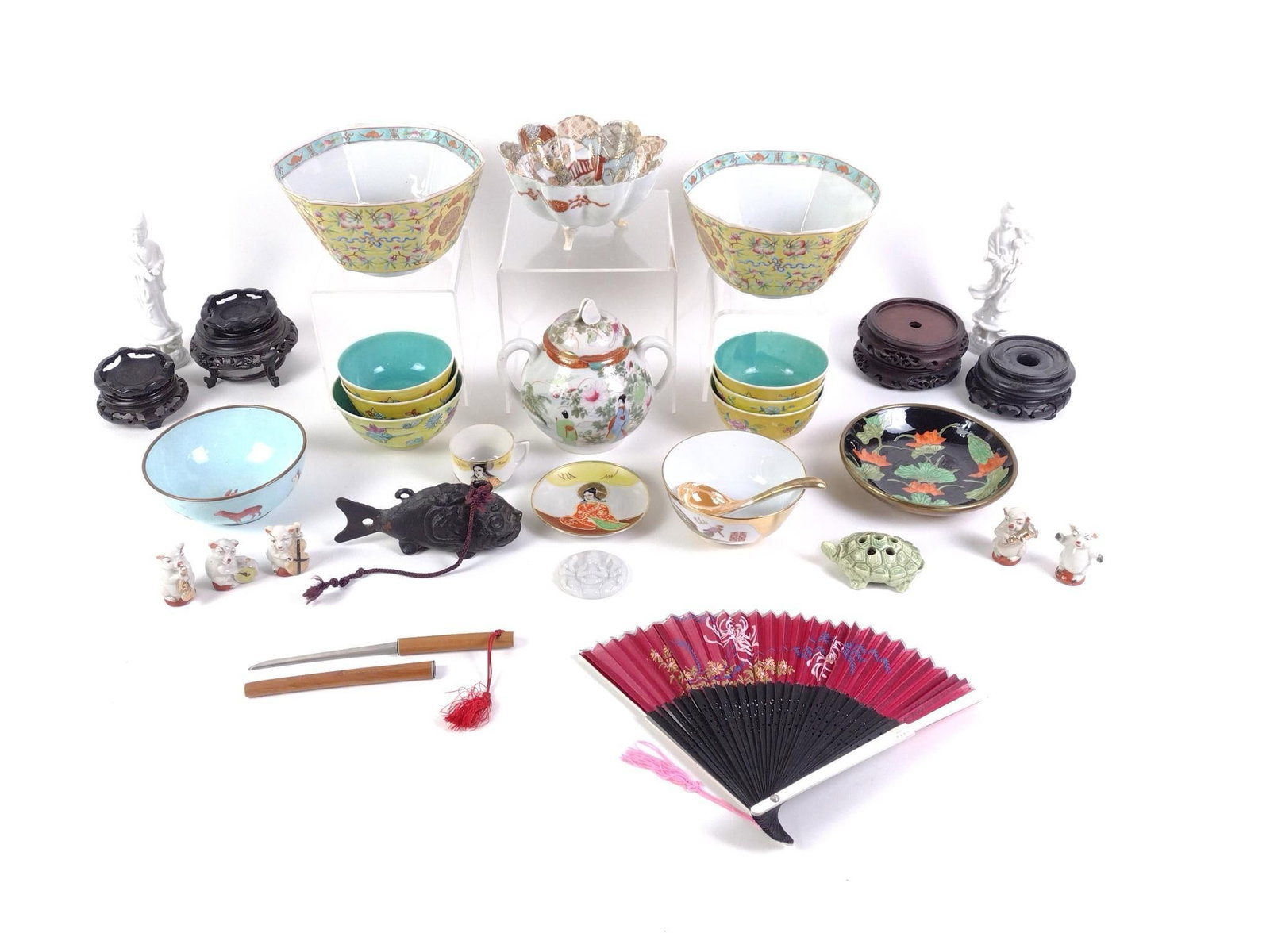 Asian Collectibles: Includes 11 bowls, 2 statues, 5 pig figurines, a katana shaped letter opener, a cast iron fish bell and a paper fan.