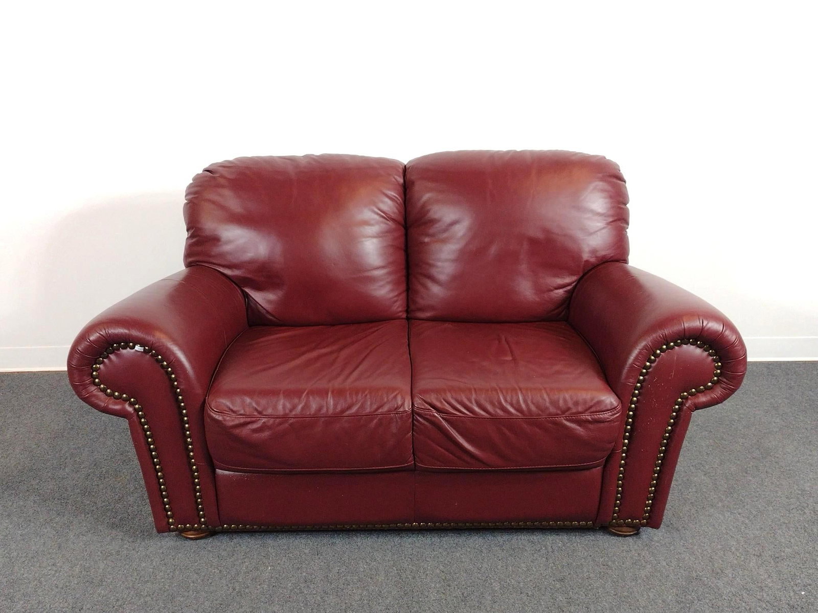 Chateau d'ax Leather Loveseat: 65" wide X 34" deep X 36-1/2" high. Has scratches. No manufactures name found.
