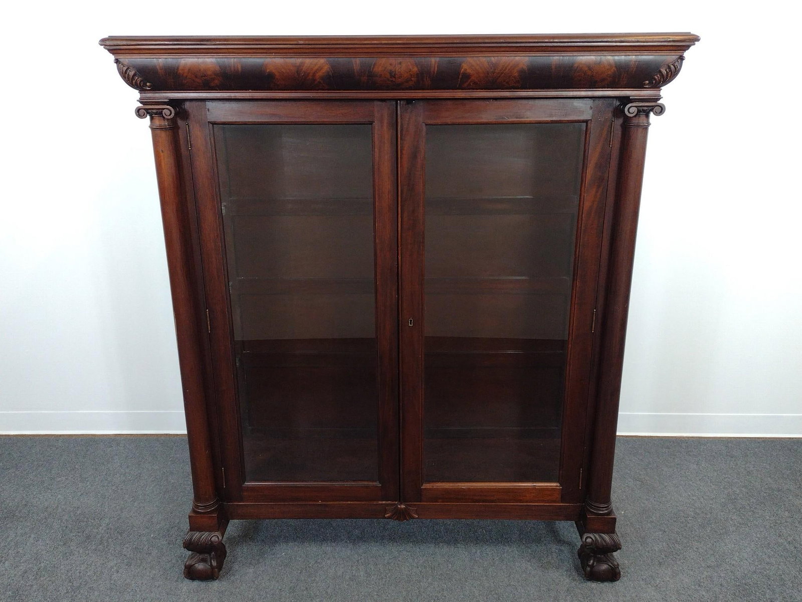 American Empire Style Glass Door Bookcase: 52-1/2" wide X 18-1/2" deep X 60" high. Has a few light scratches. Missing glass shelves.