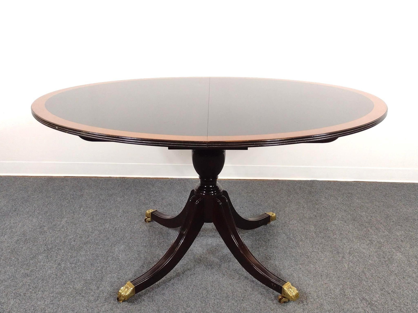 Stickley Pedestal Dining Table: Table 54" wide X 45" deep X 30" high. Has some light scratches. Two leaves, each 20" wide.