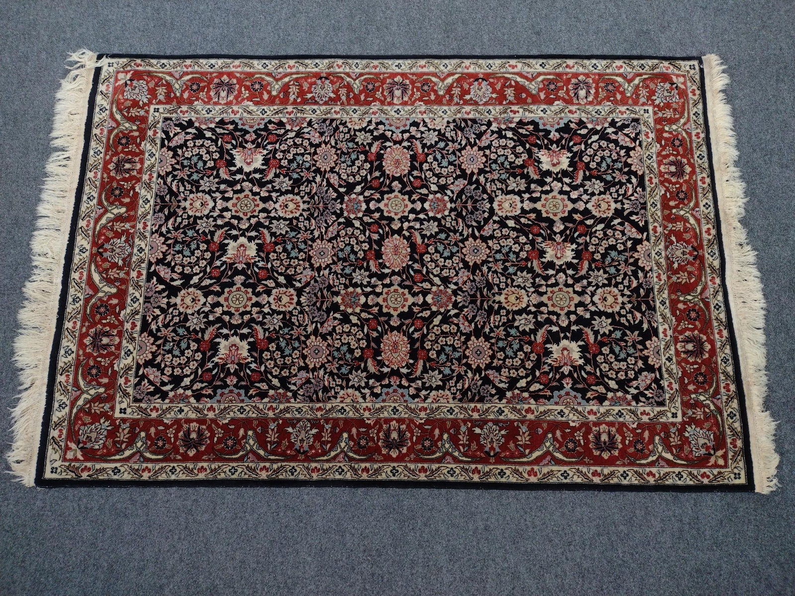 Hand Woven Kashan Oriental Area Rug: 6' long X 4'3" wide. Country of origin is the Peoples Republic of China. Fiber content: woolen pile.