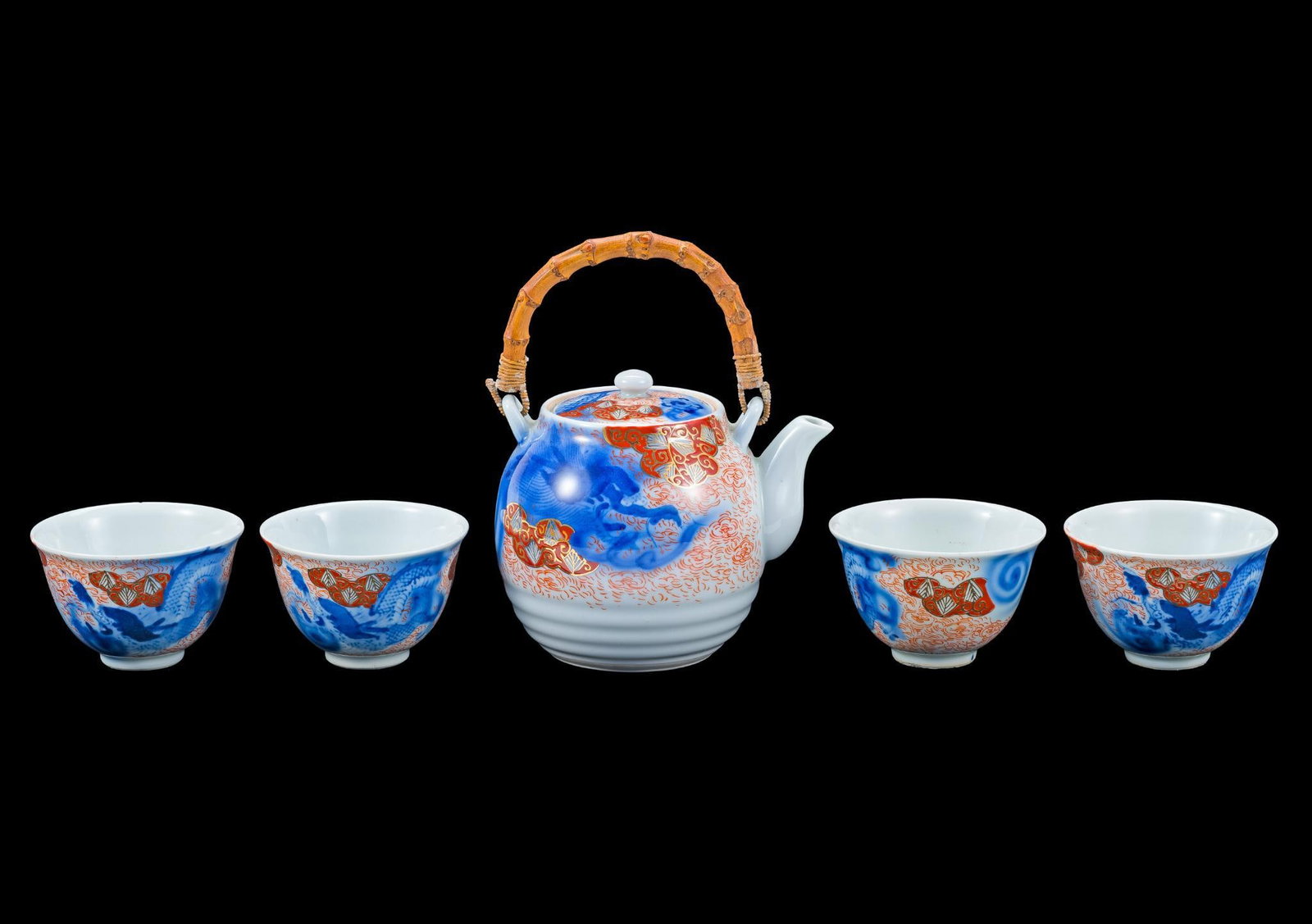 19th C Chinese Imari Porcelain Tea Set: The teapot is 5" height not including the bamboo handle and the teacups are 3 1/2" diameter. The teacups are marked to the base and the teapot is identically marked to the underside of the lid. PROVEN