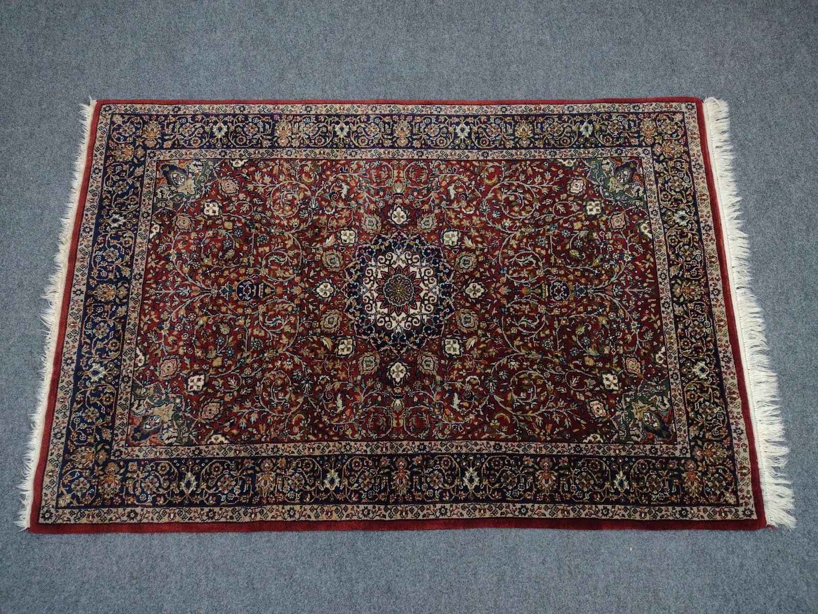 Sufian Isphahan Oriental Area Rug: 6'5" long X 4'3" wide. Country of origin: India. Pile fiber: wool. Warp fiber: cotton.