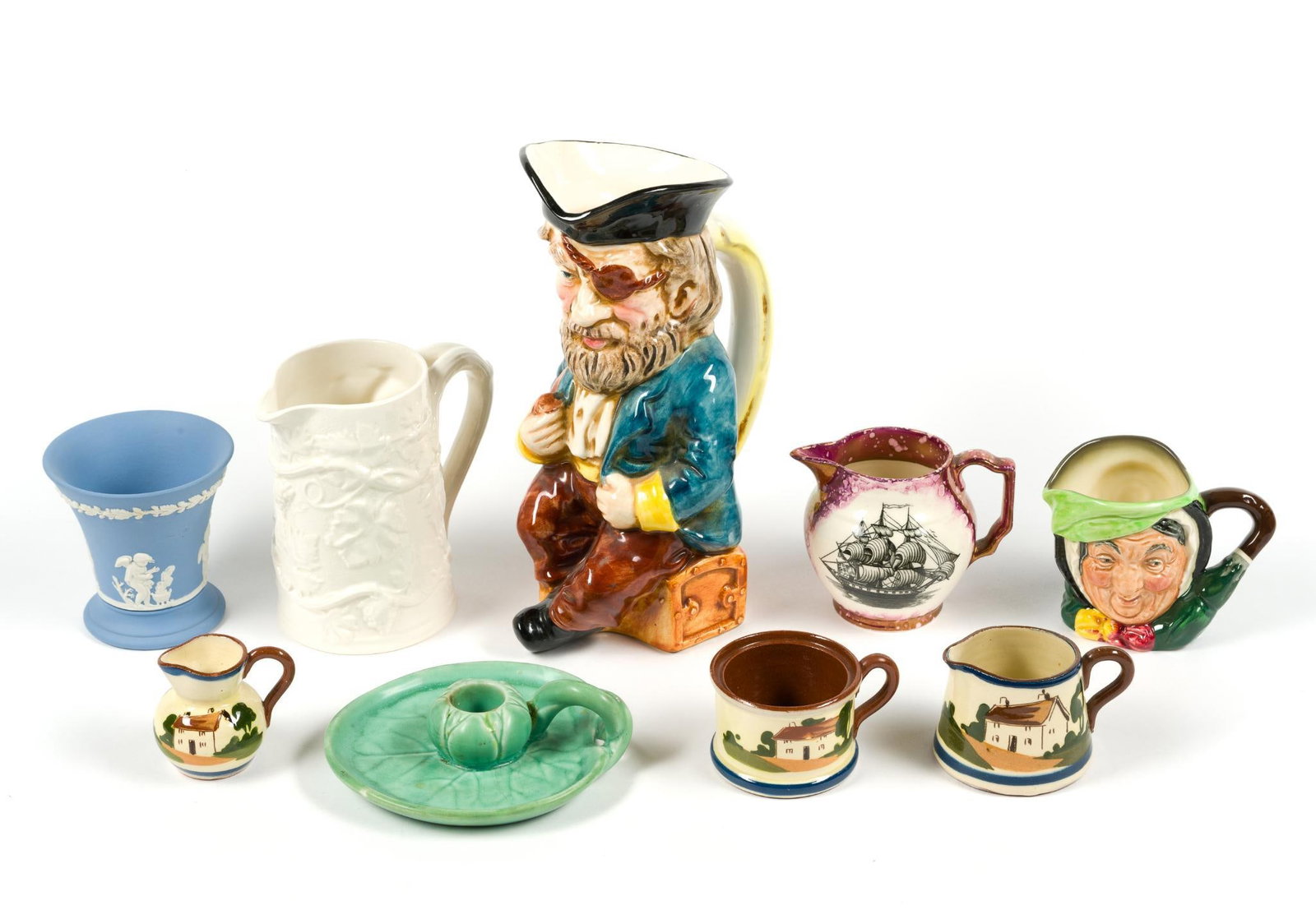 9 Pitchers & Porcelain: Includes 2 Royal Doulton pitchers, largest measures 6" x 3 - 1/2" x 9 - 1/4", smaller "Sairey Gamp" measures 4" x 2 - 1/2" x 3". Also includes Copeland, Wedgwood, Rookwood Art Pottery, and Greys Potte