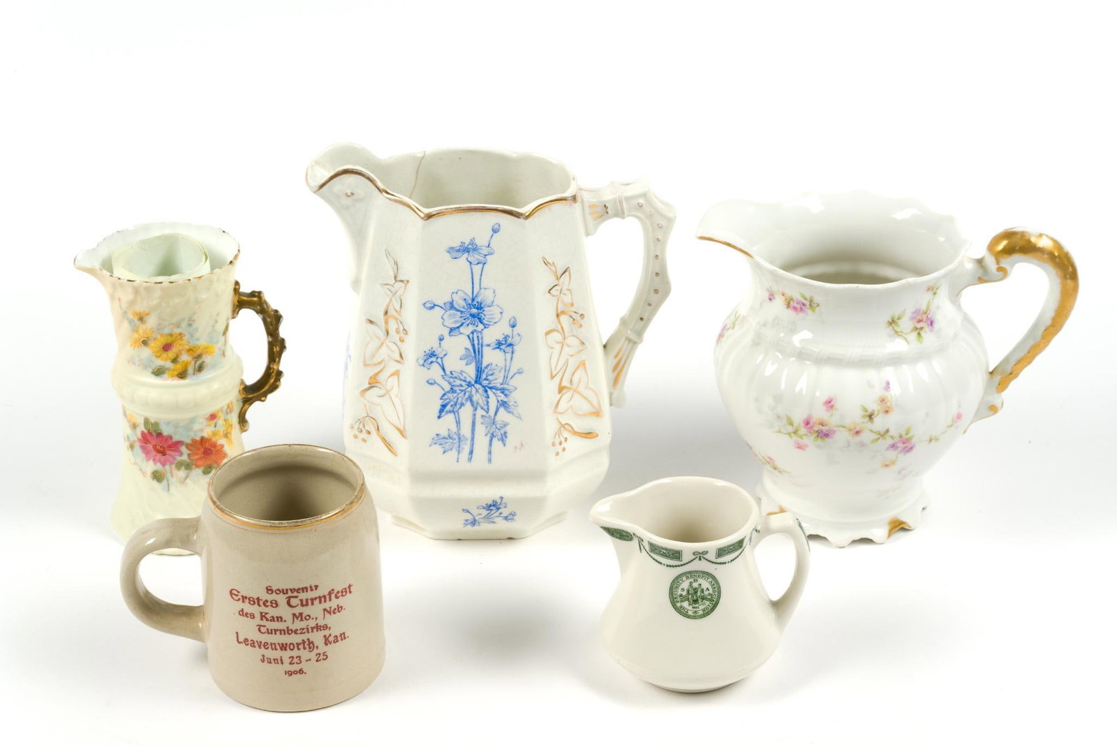 5 Porcelain Pitchers & Mugs: Includes Warwicks, Haviland and Rudolstadt. Also includes a commemorative mug from Leavenworth, Kansas. Largest pitcher measures 7 - 1/4" x 3" x 8". Smallest measures 4" x 4 - 1/4" x 3 - 1/4".