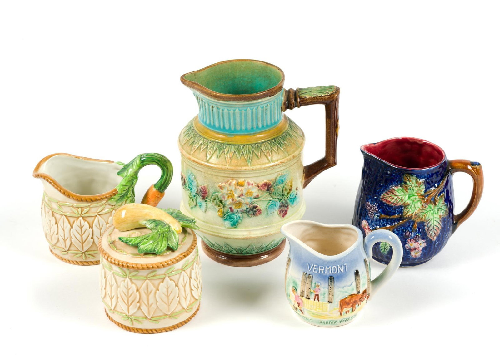 5 Vintage Majolica Pitchers & Cups: Includes Fitz & Floyd "Le Canard" creamer and sugar bowl set, Stafforshire creamer cup, Vermont cup and large antique Majolica pitcher, which measures 6" x 4 - 1/2" x 7 - 1/2".