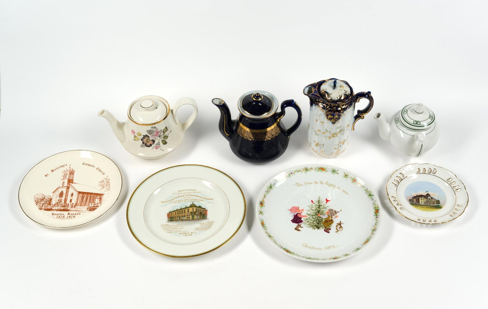 4 Porcelain Teapots & 4 Commemorative Plates: Largest plate measures 10 - 1/2" in diameter, and the smallest measures 7" in diameter.