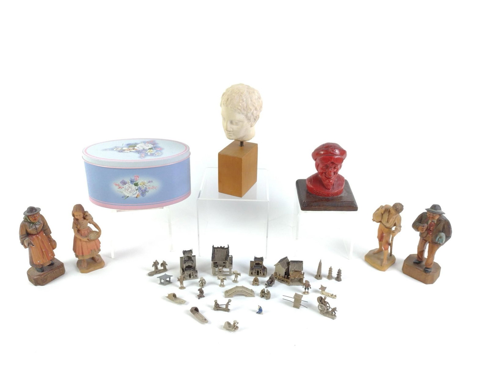 Figurines & Statues: Includes vintage Chinese mudmen figurines and houses, a vintage red Bosch Equip promotional bust, vintage plaster bust depicting the Roman Emperor Augustus, 2 hand carved vintage wooden statues, and 2
