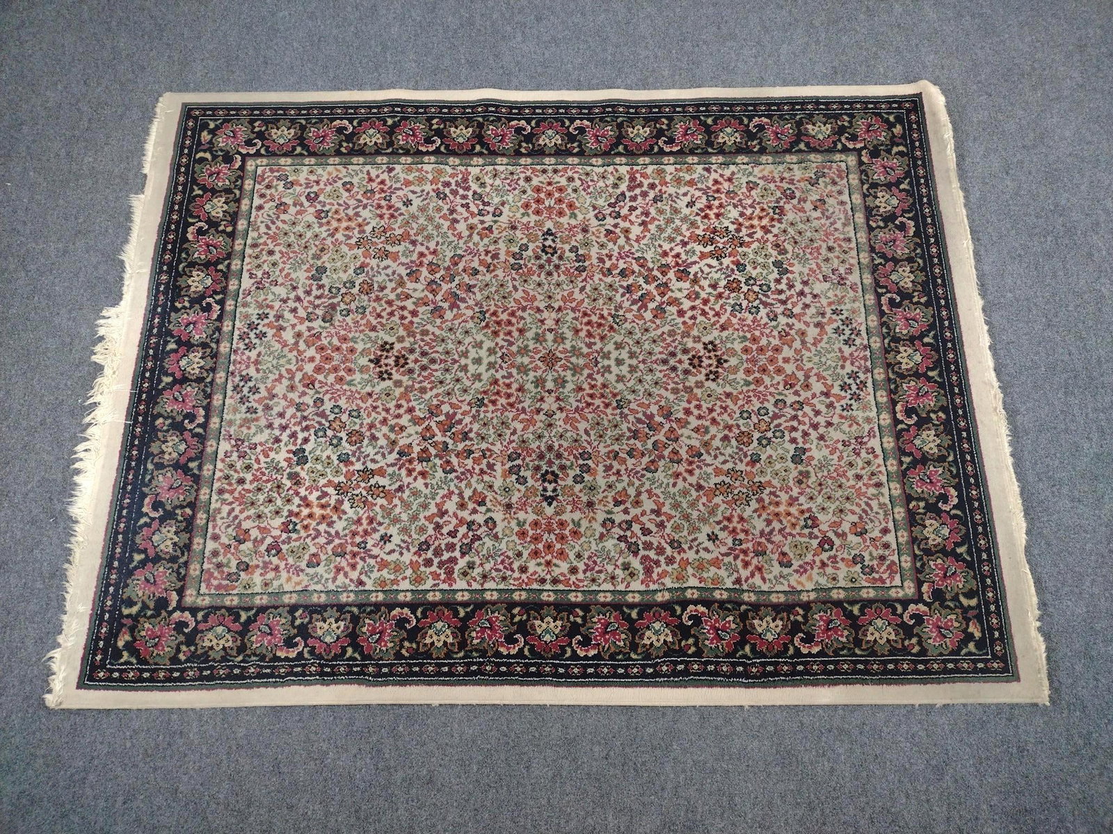 Persian Kerman Area Rug: 7'7" long X 5'8" wide. Has some discoloring.