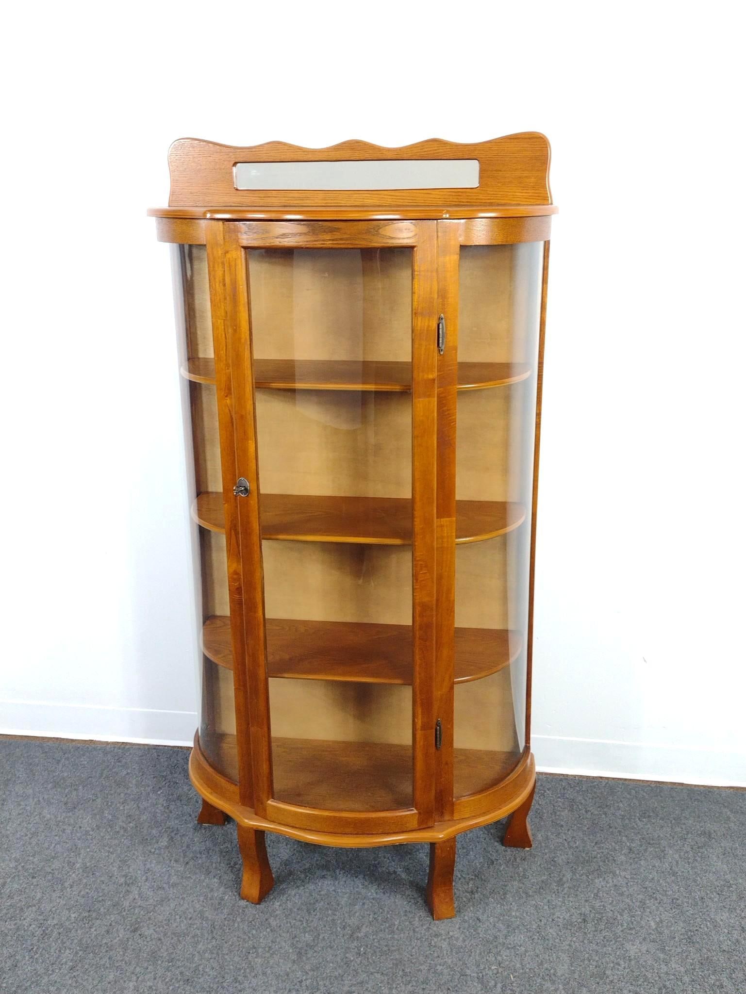 Curio Cabinet: Curved glass front and mirrored crown. 31" wide X 14" deep X 61-1/4" high.