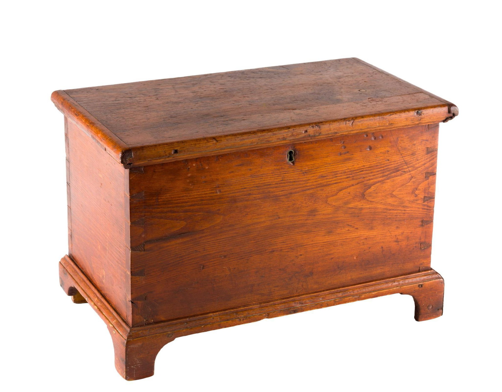 (Early Republic Era) Antique Child's Pine Blanket Chest: The antique chest is constructed in pine with dovetail edge joints and dowels and square nails to the base. The locking hardware is original and the lid hinges are replacement.It is 19-1/2" wide X