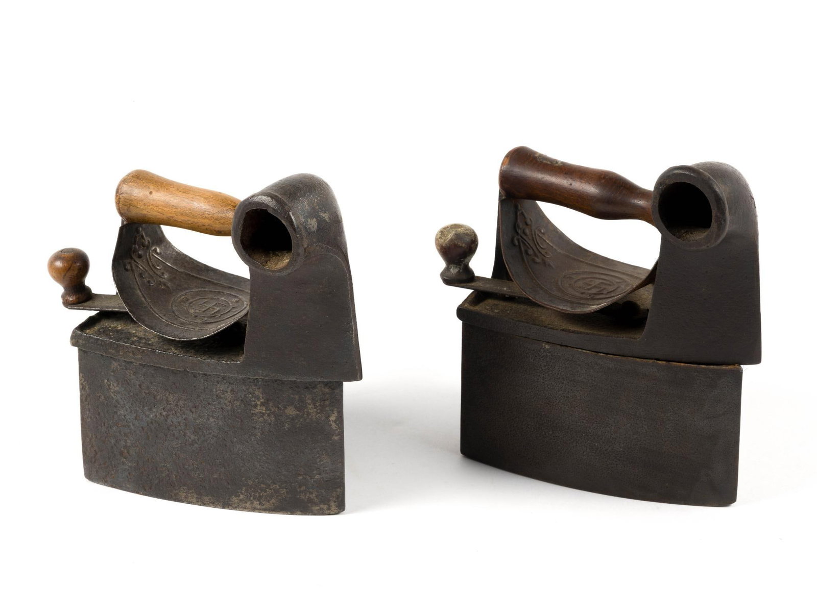 (Reconstruction Era) 2 Antique Box Irons: From a private collection. Both irons measure 7 - 1/2" x 4 - 1/2" x 8".?Before being appropriated by the Nazi Party in the 1930s, the swastika was universally used across North America, Europe, and As