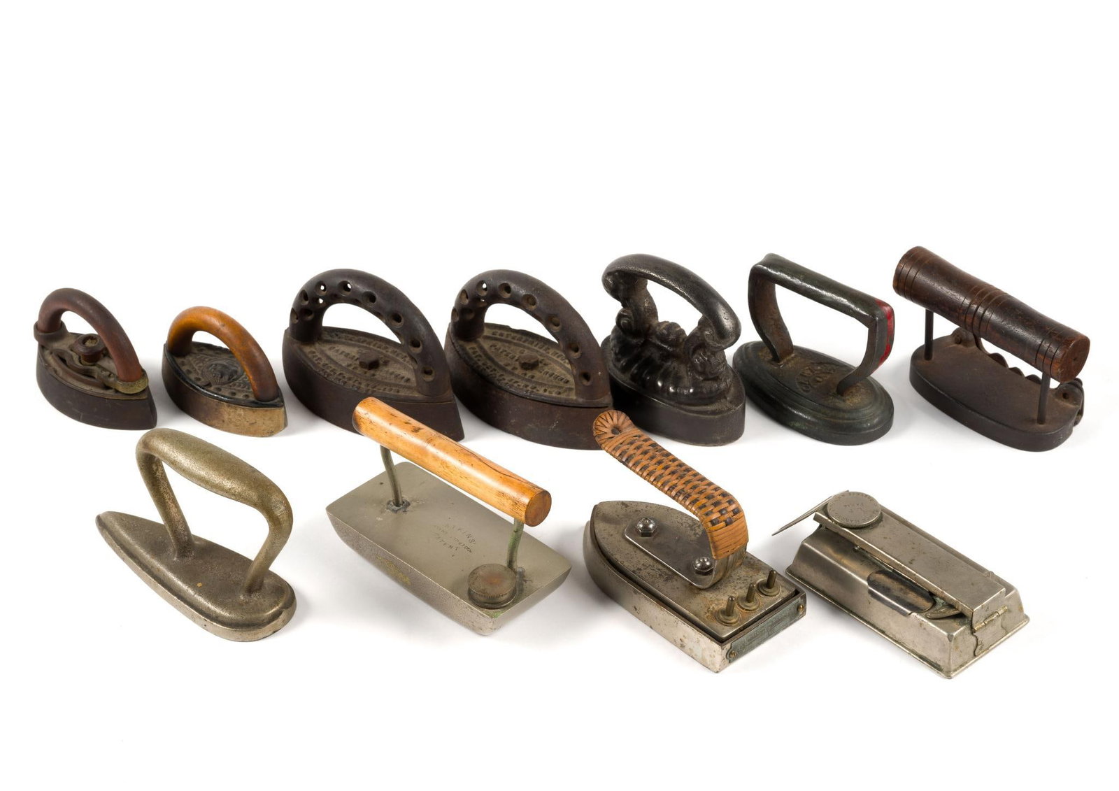 (Reconstruction Era) 11 Antique Sad Irons & Flatirons: From a private collection. Largest iron measures 4" x 2" x 4" and the smallest measures 3 - 3/4" x 1 - 3/4" x 2 - 1/2".