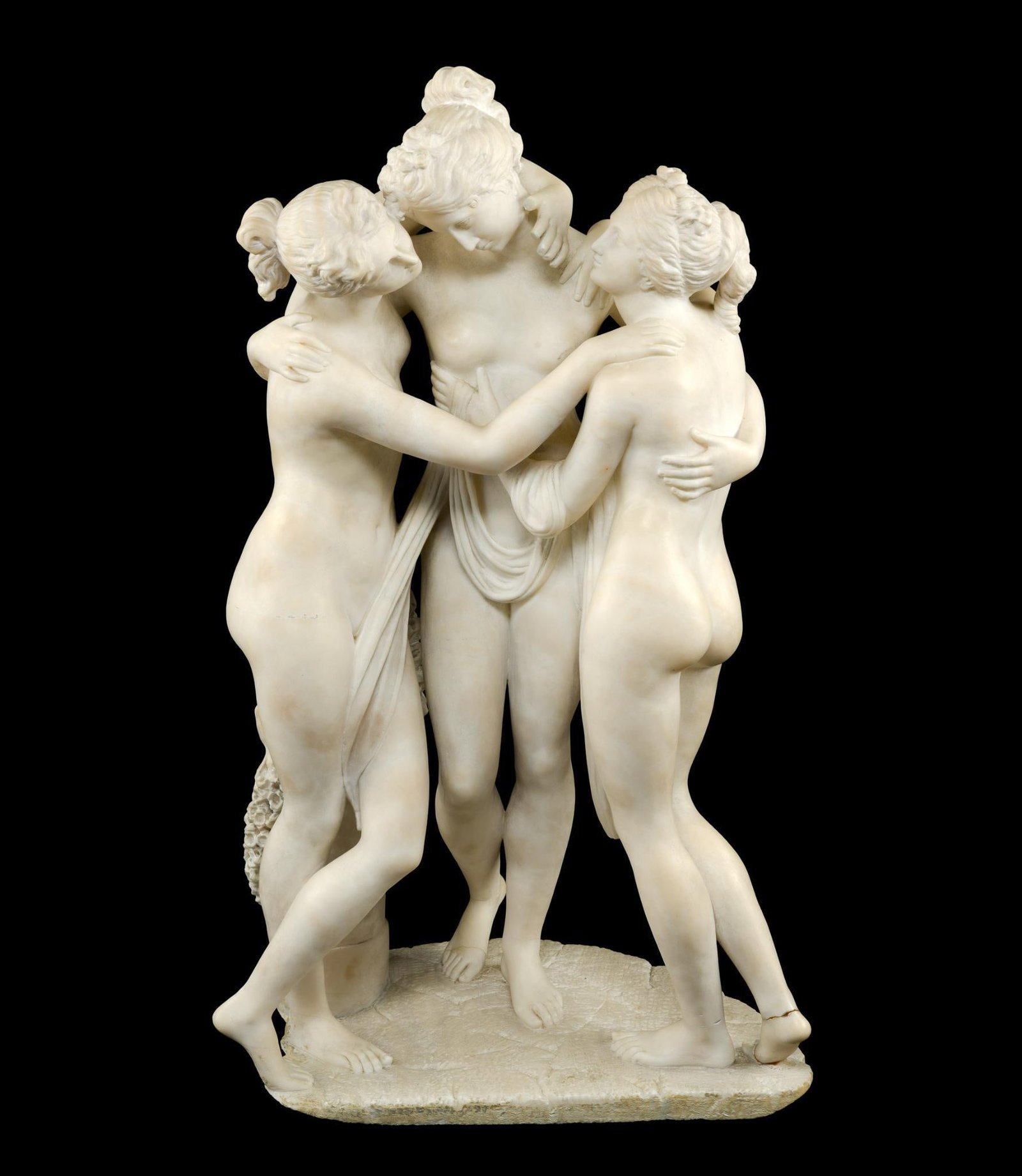 Stone Statue After Antonio Canova: A reproduction of The Three Graces by Antonio Canova,.22 1/2" in height. The piece has repairs at the feet and losses to the finger tips of one hand.