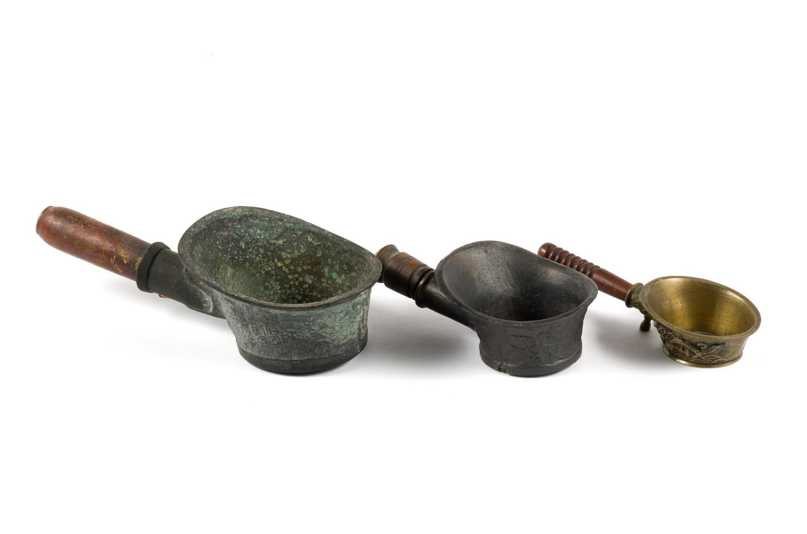 3 Chinese Silk Irons: From a private collection. Includes a bronze Qing dynasty silk iron measuring 12" x 5 - 1/2" x 3 - 1/2", a 20th century brass iron measuring 8 - 1/2" x 3 - 1/2" x 1 - 3/4" and a cast flatiron measurin