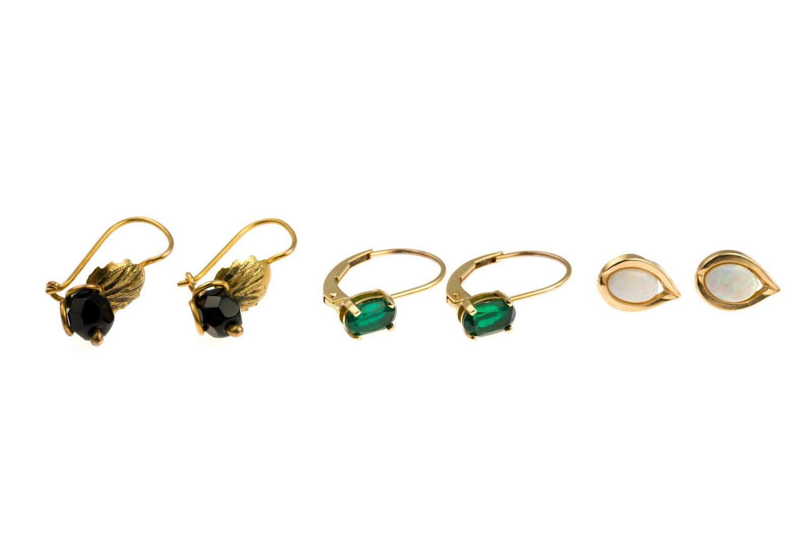 Three Pairs 14K Gold Earrings: One pair of opal studs testing 14k, one pair of antique earrings with onyx testing 14k and one pair with oval faceted emeralds marked 14k. All are yellow gold and for pierced ears. Total weight is