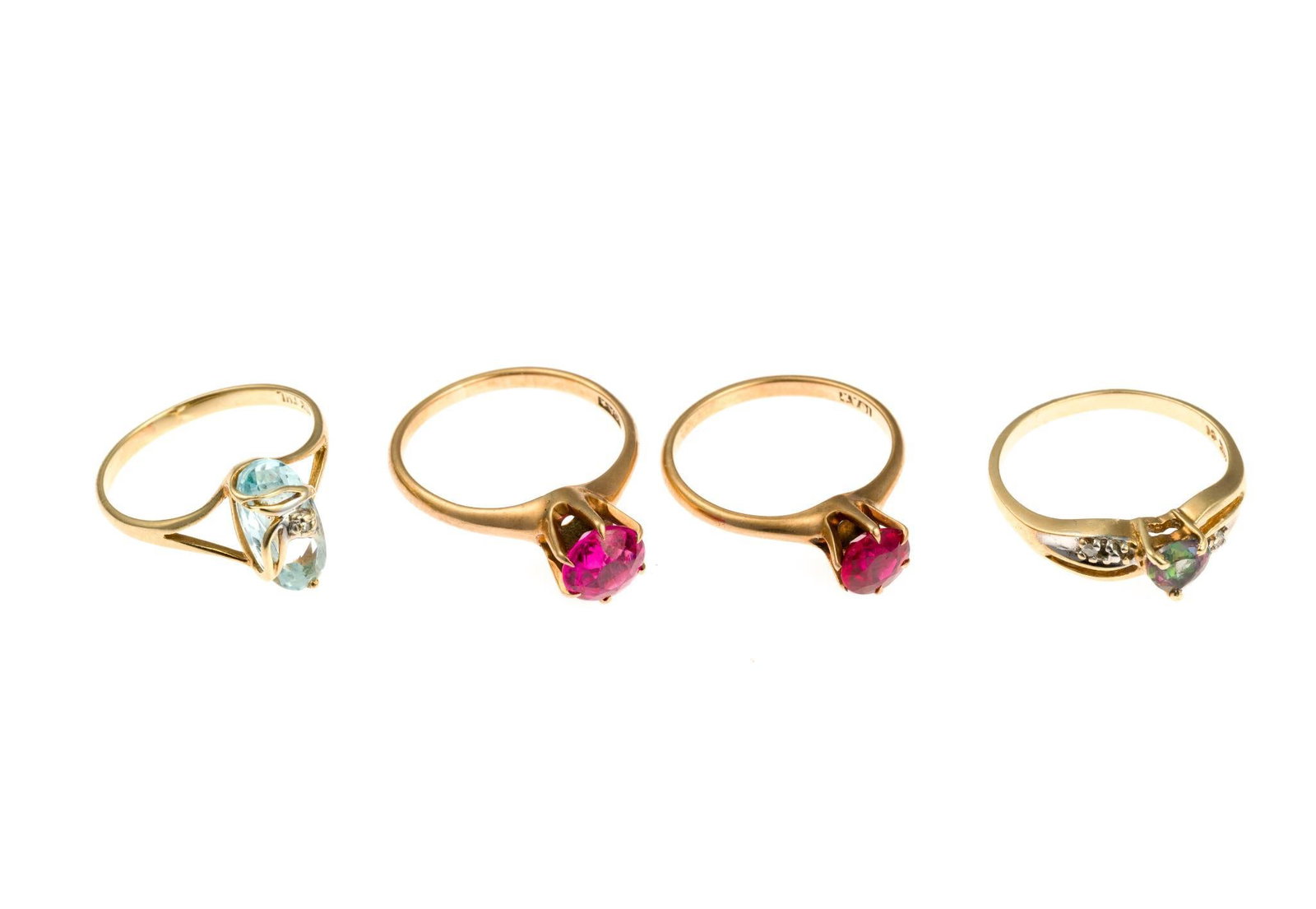 Four 10K Gold Gemstone Rings: All four rings are size 6.5 to 7. The total weight of the rings is 8.4 grams.
