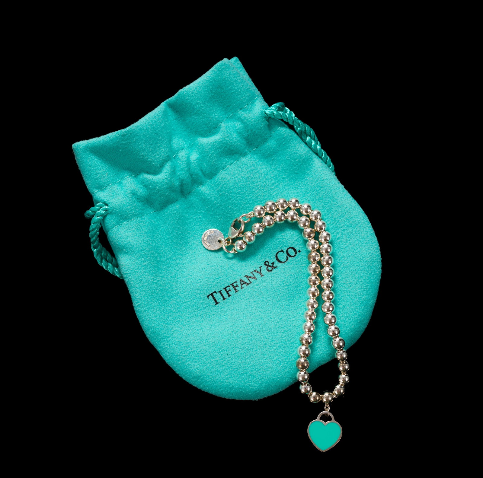 Tiffany & Co Sterling Silver Bead Bracelet: A like-new 7" bead bracelet with original pouch and box. It has a Return To Tiffany heart charm.