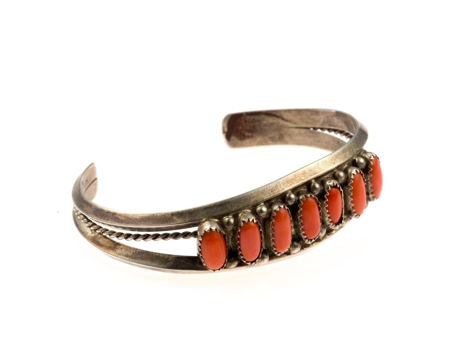 Vintage Navajo Coral and Sterling Silver Cuff Bracelet: 2 3/8" inner width with 1 1/4" opening and 3/4" width. The piece is signed by (apparently) Kevin Yazzie. Weight is 0.8 troy ounces.