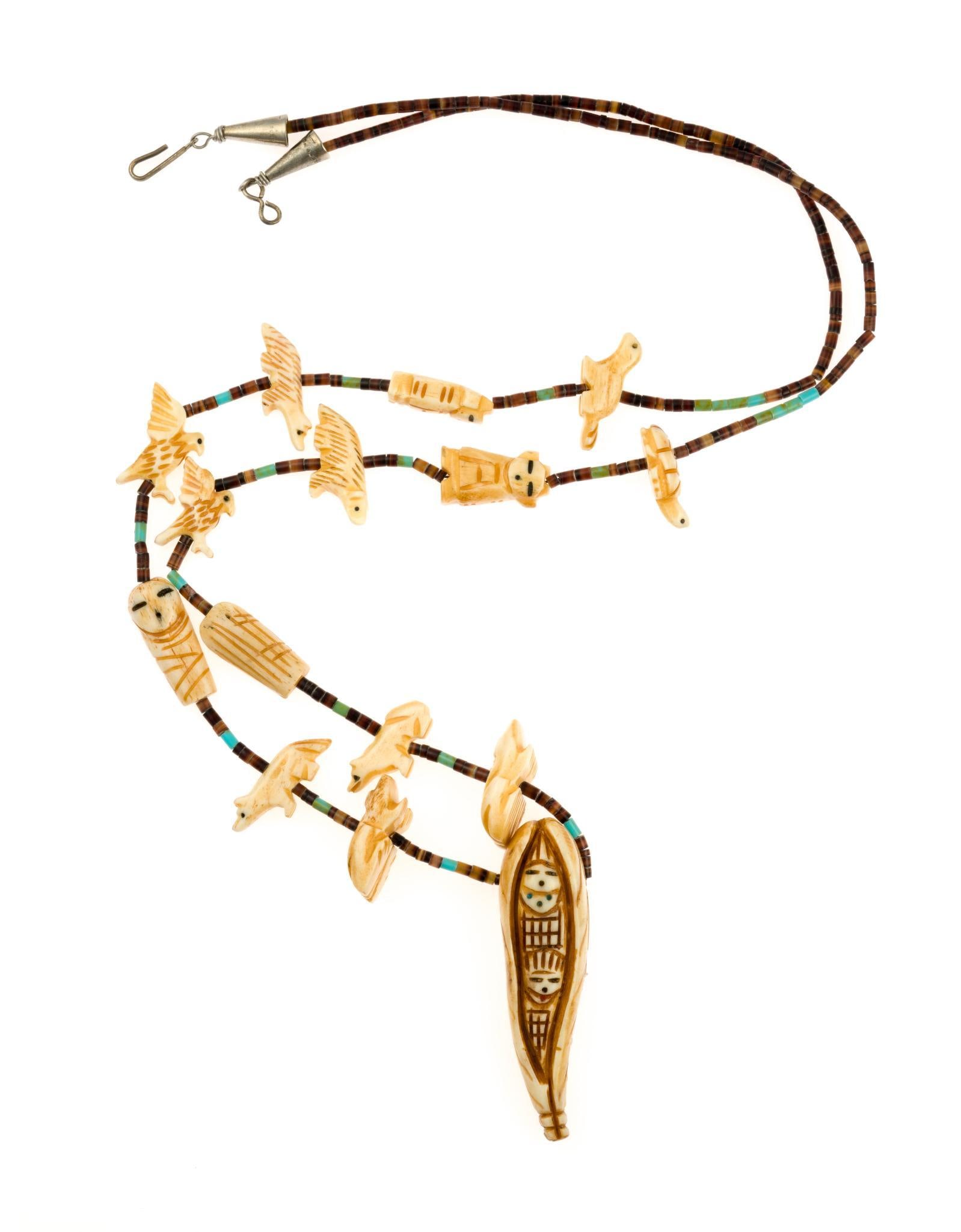 Vintage Zuni Fetish Necklace: Heishi bead necklace with fetishes. The necklace is 31" length with the central Corn Maiden being 2 1/4".