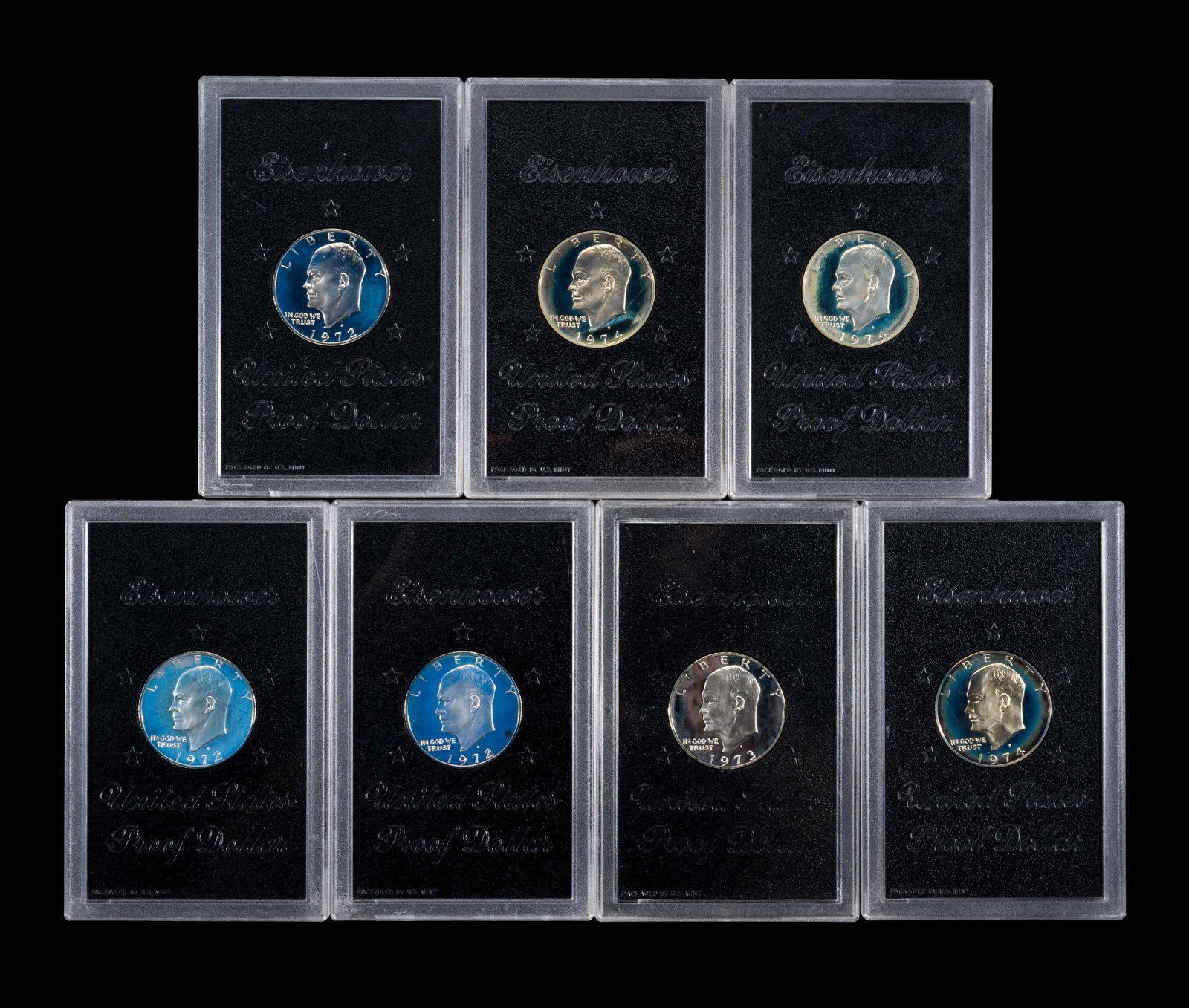 Seven Proof Silver Eisenhower Dollars: The silver proofs are in original acrylic holders.