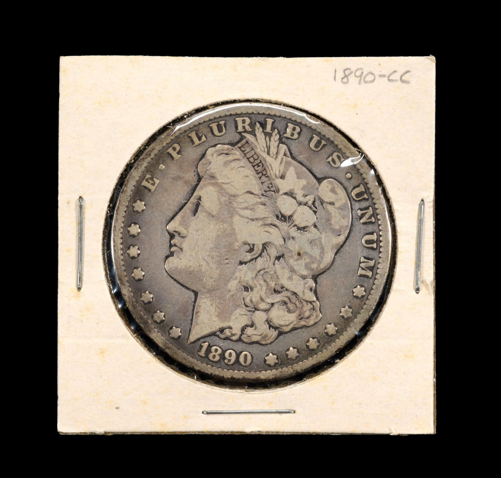 1890-CC Morgan Dollar: 1890 Carson City silver dollar in VF condition with good surfaces.