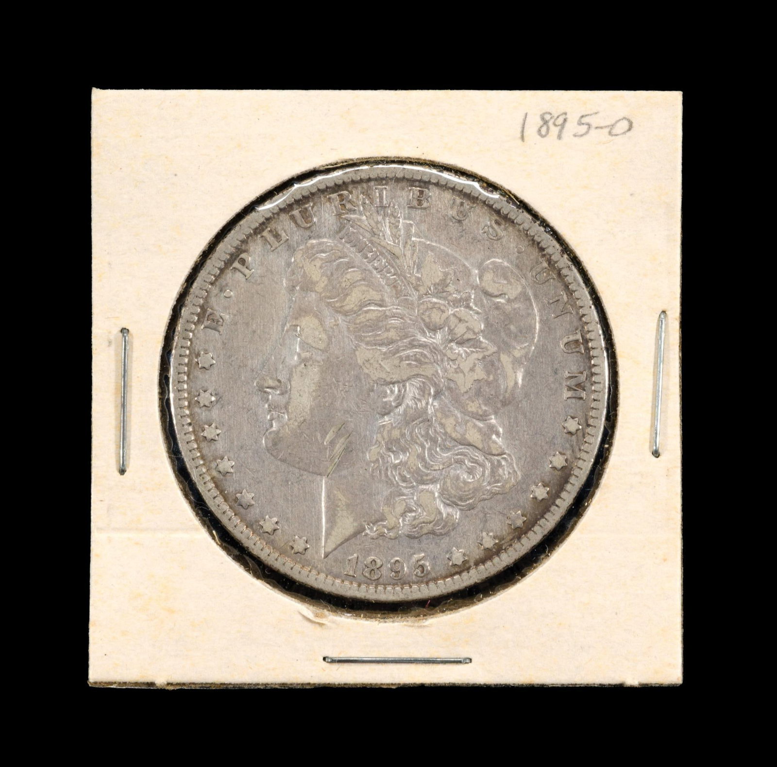 1895-O Morgan Silver Dollar: Good surfaces, XF except note cheek marks.