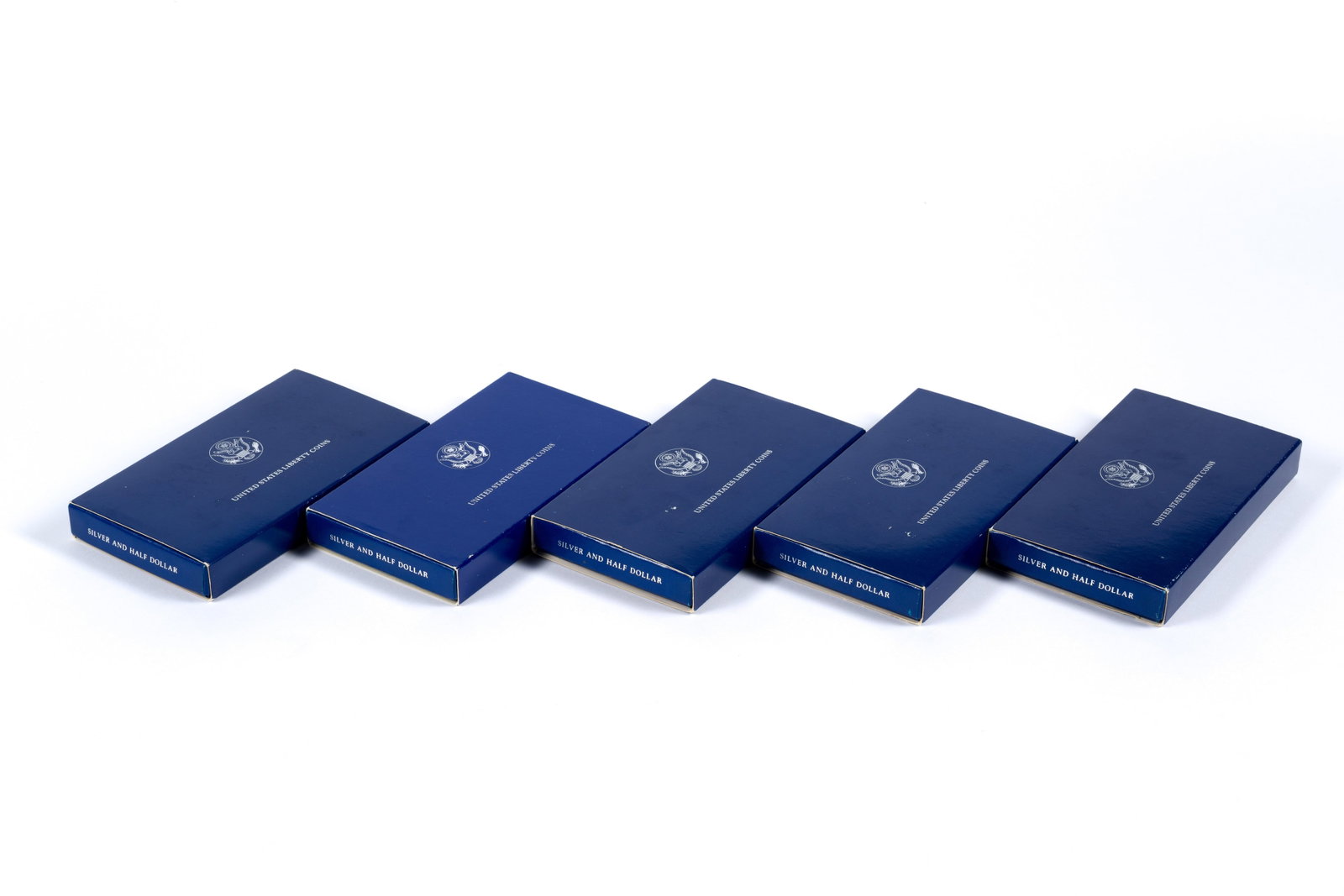 Five Sets United States Liberty Coins: Each set contains a proof silver dollar and clad half dollar. All have boxes and papers except one missing it's papers.