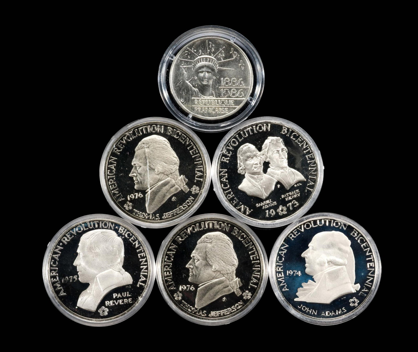 Six Silver Commemorative Coins: 1986 Piedfort .900 silver 100 francs (.87 troy ounces pure silver), and five silver commemorative proof U. S. coins 31.1 grams sterling silver each.