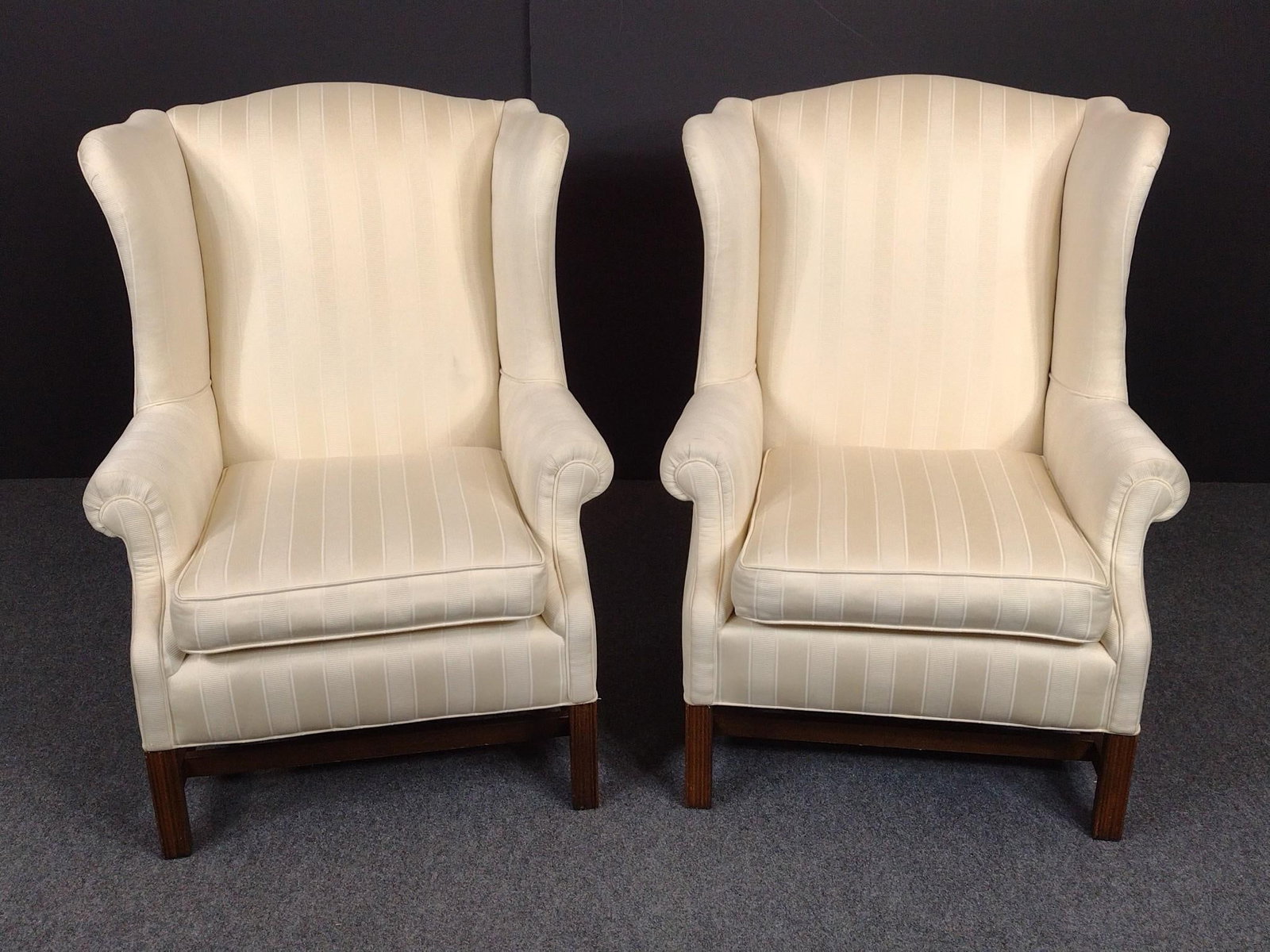 Pair of Upholstered Wing Back Chairs: Each 31" wide X 30" deep X 42" high. Both have small areas of light discoloring. No manufactures name found.
