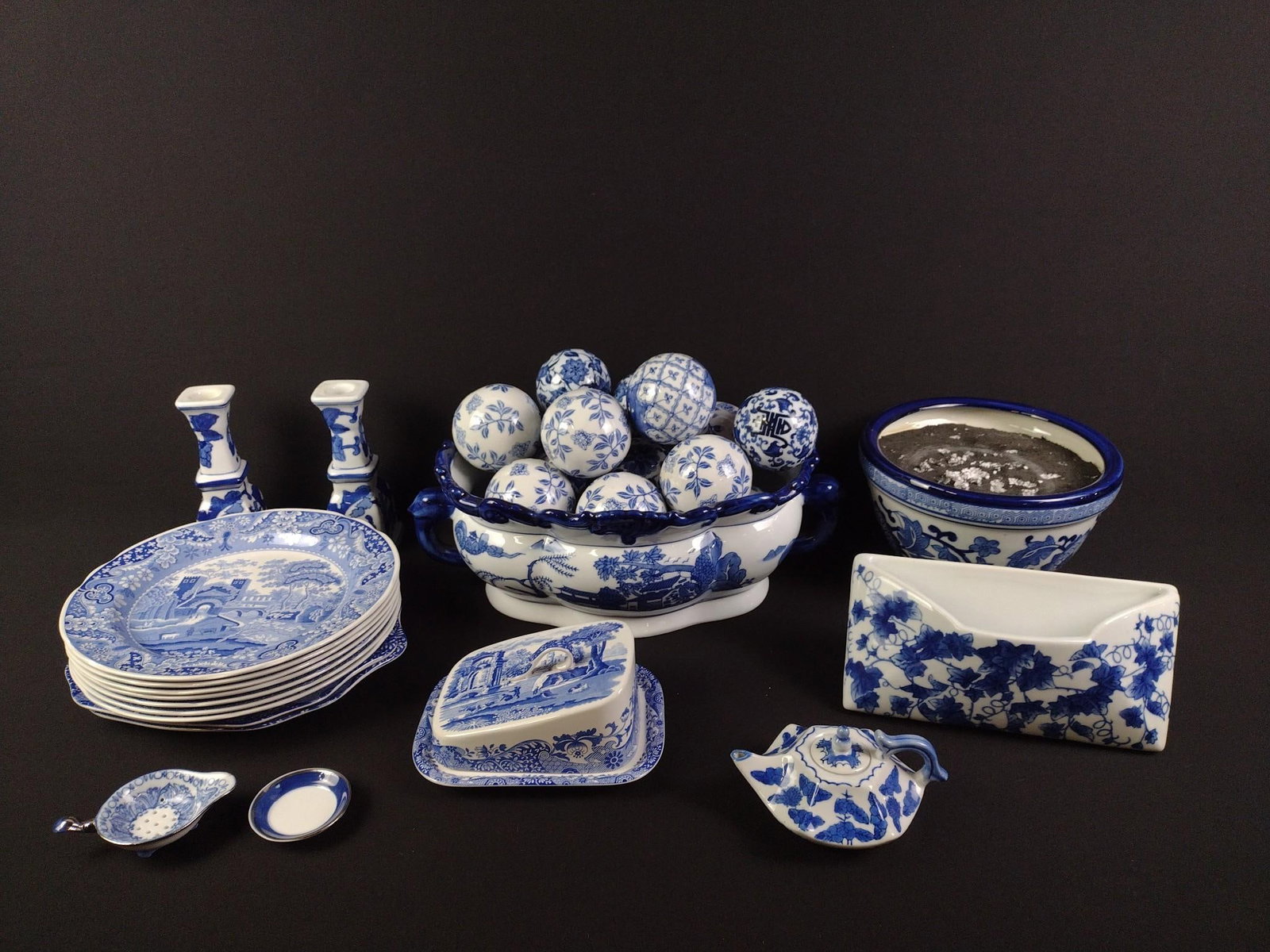 36 Pieces Blue & White Ceramics: Includes large bowl with 18 porcelain balls, 9 plates, a planter, a teapot, a butter dish, 2 candlesticks, 2 small dishes and a ceramic letter holder. Largest bowl measures 16" x 9-1/2" x 6-1/4", and 