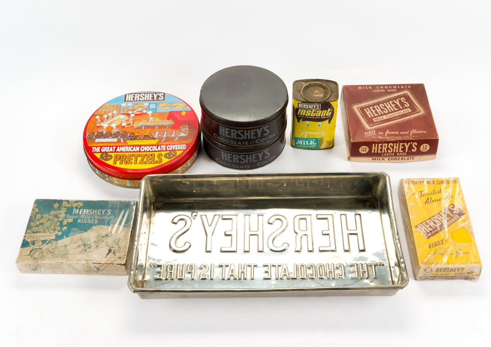 8 Vintage Hershey's Items: Includes tins, advertisement boxes, and Hershey's cake pan, 19-1/4" wide x 2-1/2" high. 