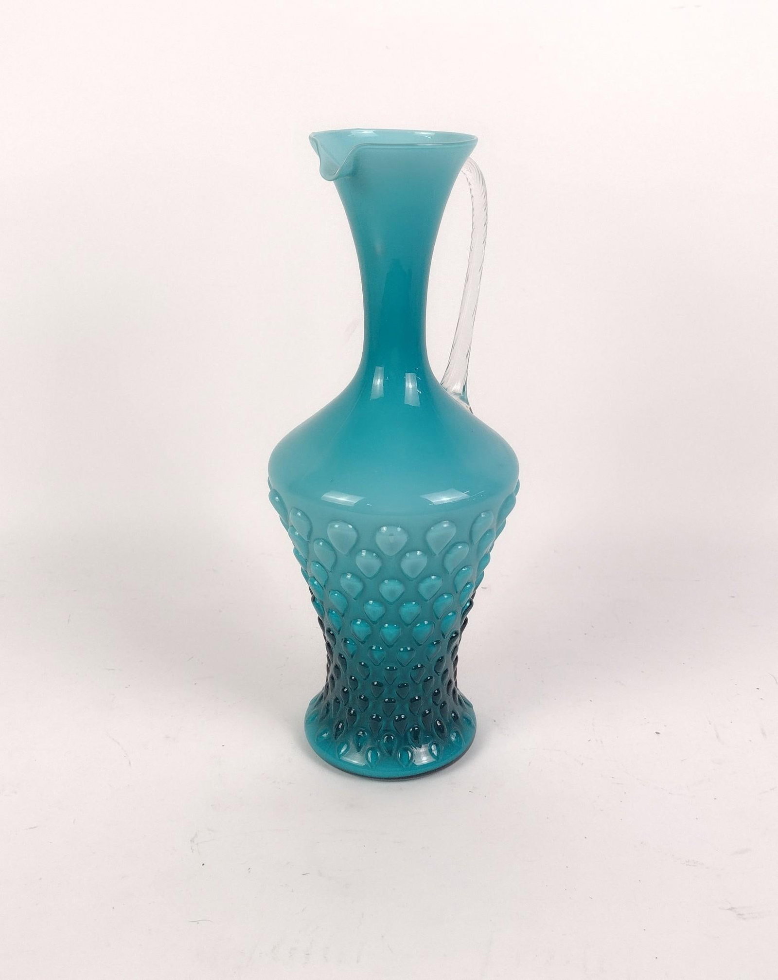 1960's Mid-Century Empoli Opaline Glass Pitcher: Features a distinctive aqua-blue teardrop texture and a distinctive applied handle. Measures 6-3/4" x 6" x 15". 