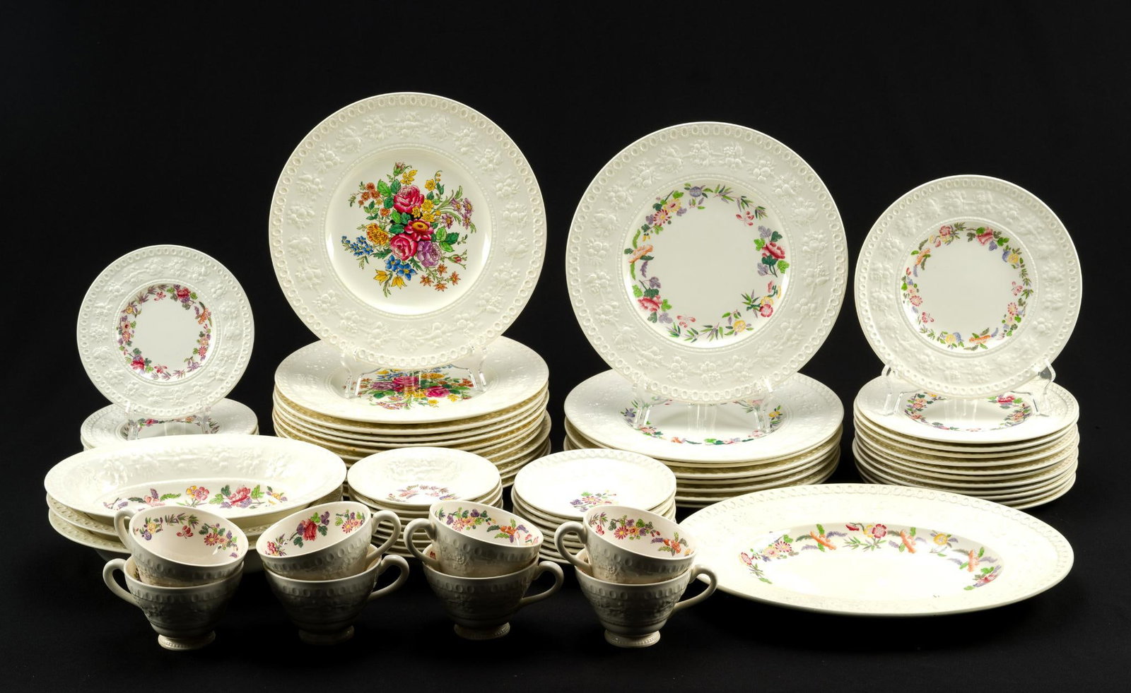 Wedgwood Wellesley Porcelain Dinner Service: Wellesley pattern 93217, Wedgwood of Etruria & Barlaston. The dinner plates are a variation of the Wellesley pattern, Ullswater, with a floral center section. All are ivory porcelain. The set includes