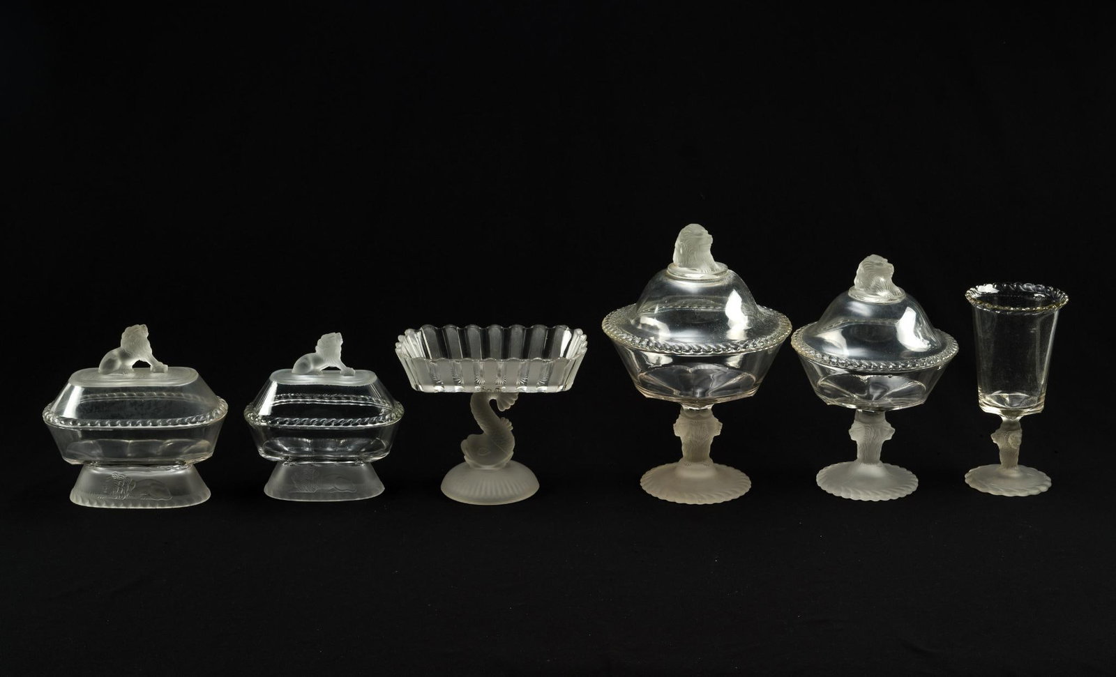 6 Gillinder & Son Glass Frosted Lion Serving: C. 1880s. Includes 4 covered compote dishes, a celery vase, and an open compote dish without a lid. Overall, 8" to 12" tall. Excellent condition with normal wear and tear associated with age. 