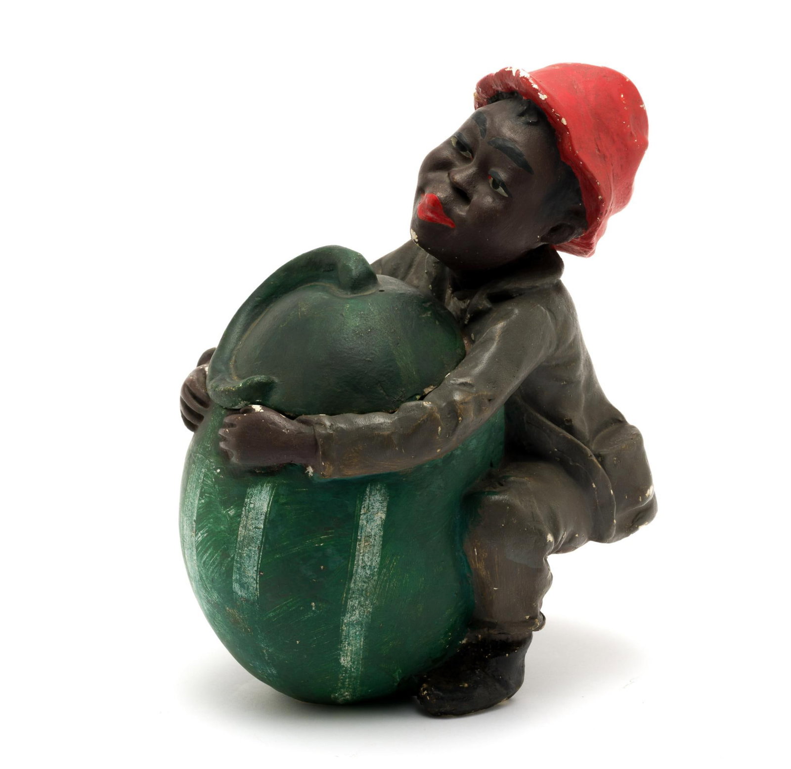 J. Naddi Boston Pottery Black Americana Humidor: Late 19th Century; Original; 6-1/2" x 8-1/2" x 11"; lidded tobacco humidor; young African American boy holding a watermelon; some paint losses to the chin, chest, hat, and back of the little boy. 