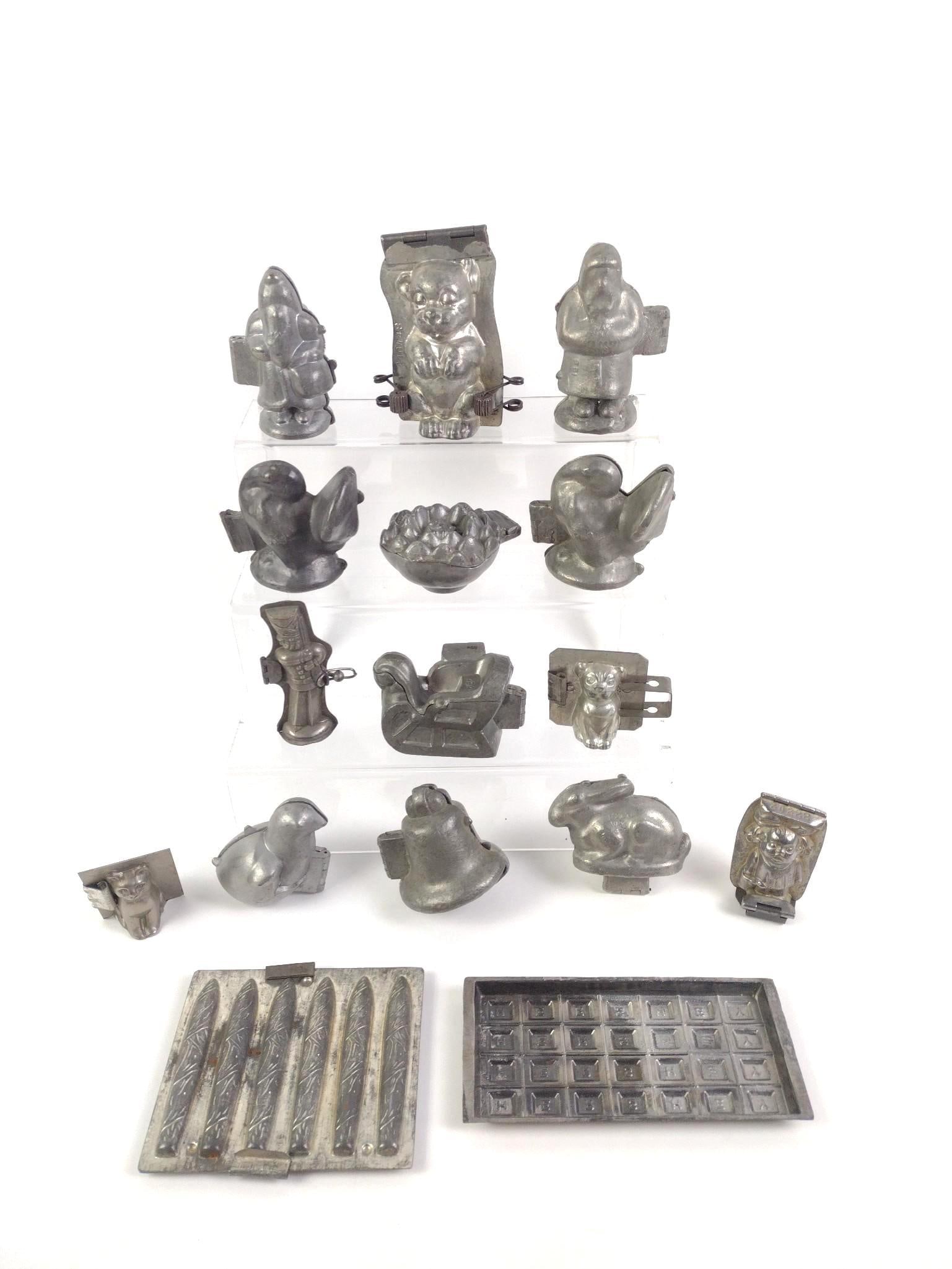 16 Assorted Vintage Chocolate Molds: Includes bears, chickens, Hershey bars, soldiers, cats and more. Largest bar mold measures 7-1/2" x 3-1/2" and the smallest mold measures 2-1/4" x 1-3/4" x 2-3/4".