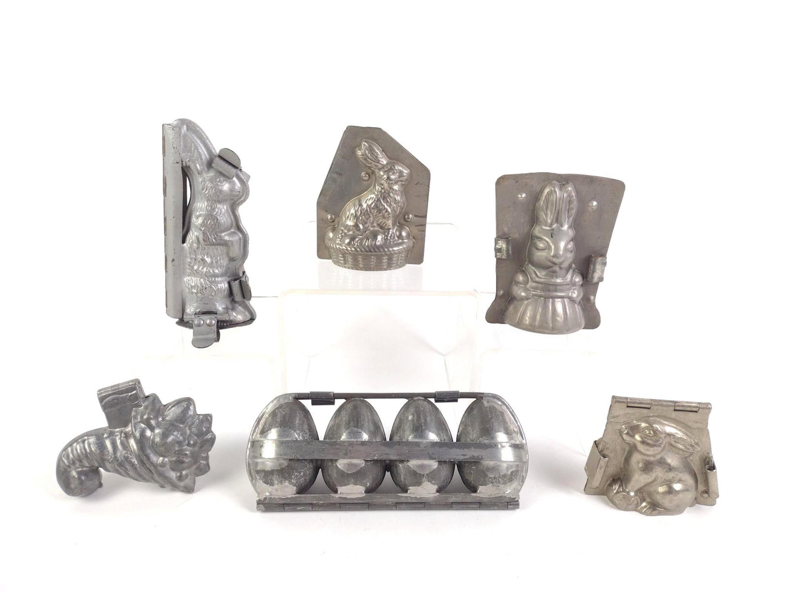 6 Antique Easter Chocolate Molds: Includes eggs, bunnies, and a cornucopia. Largest measures 8-1/4" x 2-3/4" x 3-1/2".