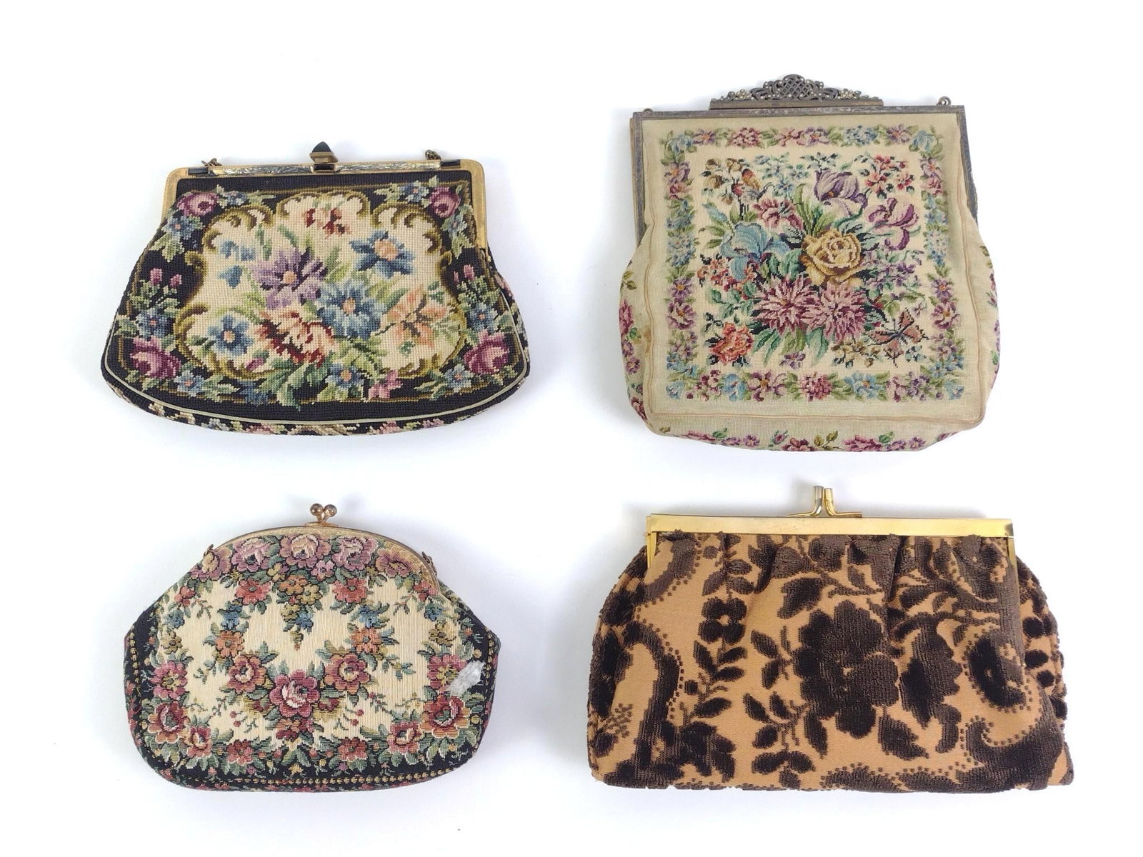 4 Mid-Century Needlepoint Handbags: All four purses have metal frames and chain straps. One made in Austria and a clutch labeled Tano and was made in Spain. Largest measures 6-3/4" x 7-1/2" and the smallest measures 6-1/2" x 5". 