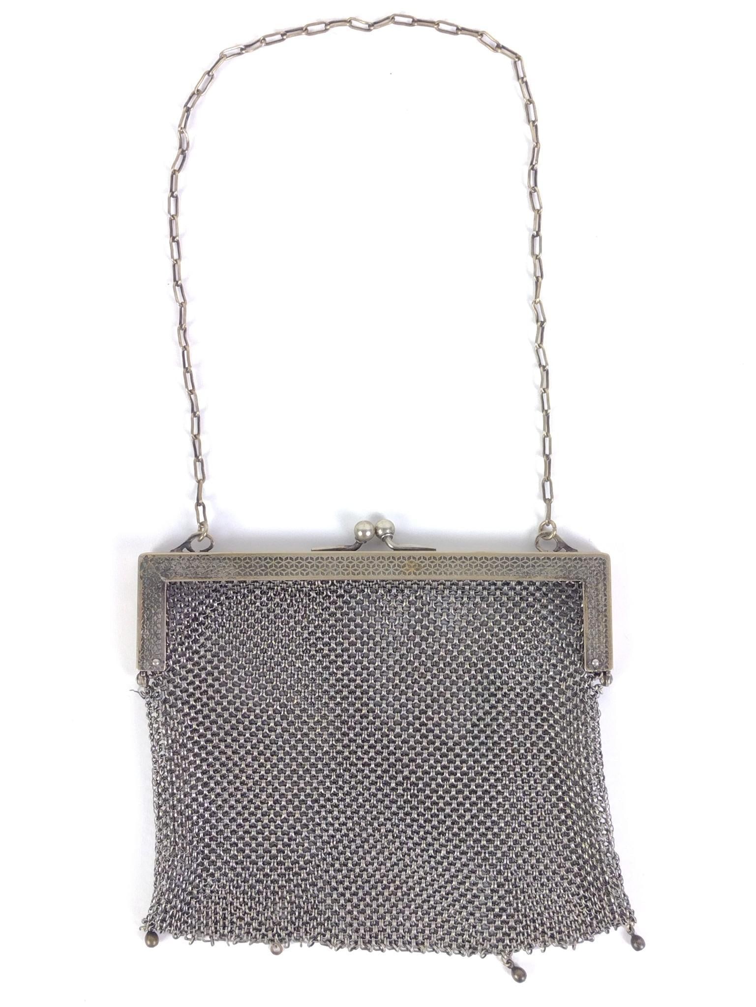 German Silver Mesh Flapper Purse: Stamped "German Silver" on the inside edge of the top of the bag; no silver content; metal alloy. Purse measures 6" x 5-1/2". 