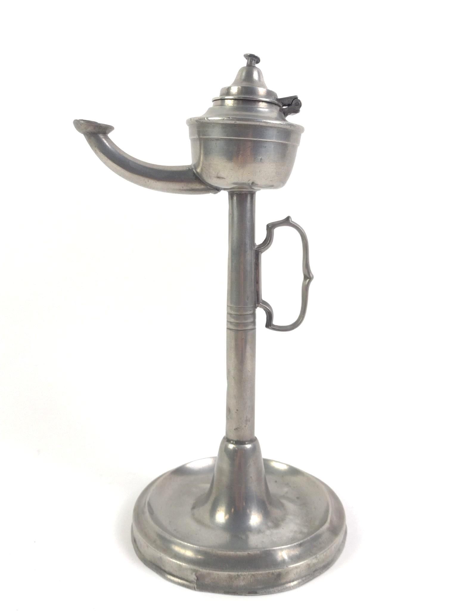 Antique Pewter Whale Oil Lamp: Indistinguishable makers mark on bottom, possibly Sheffield, some small dents and imperfections to the base and top. 18th/19th C. Measures 5-1/4" x 5-1/4" x 11-1/4".
