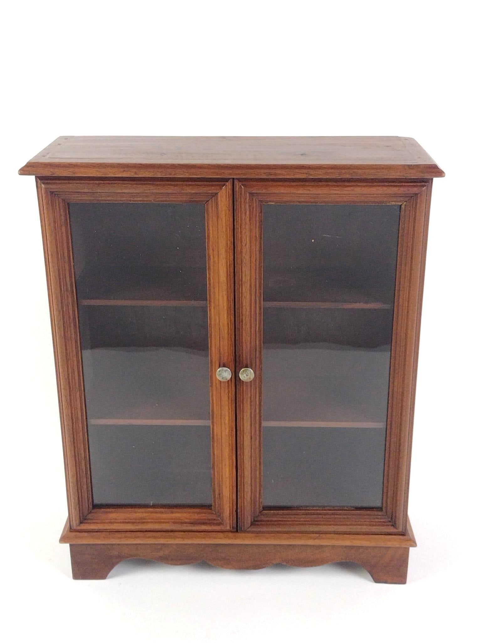 Small Tabletop Doll Wooden Cabinet: Incl 3 shelves & glass doors. In good condition, consistent with age and use. ~13-1/2" long x 4-3/4" wide x 16-1/4" tall.