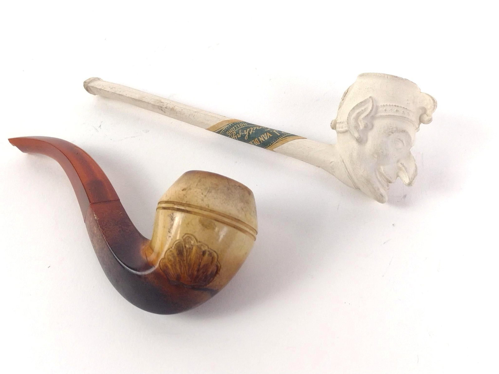 Meerschaum Pipes Incl. Gouda Holland: 2pc vintage clay pipe. 1.) Original paper label "P. J Van Der Want, Gouda Holland" and producer's stamp on the inside. Condition: good, but has a small crack at the back of the head. ~5-1/2" long. 2.)