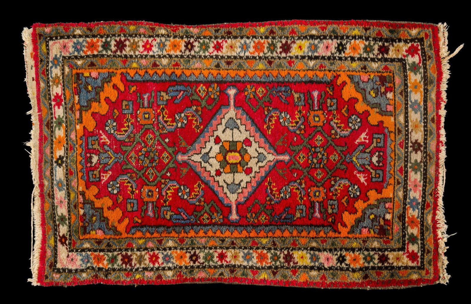 Vintage Persian Heriz-Style Wool Area Rug: Mid-20th century Persian Heriz-style hand-knotted wool rug featuring a bold ivory diamond medallion on a vivid red field surrounded by geometric floral and angular vine motifs. Heriz rugs, woven in no