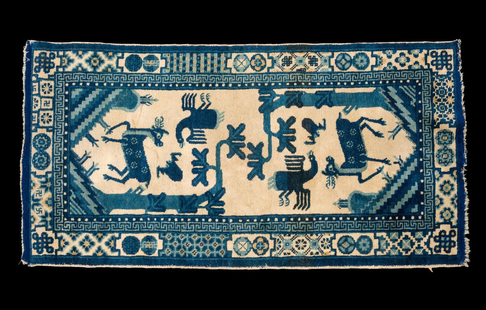 Vintage Chinese Peking-Style Wool Area Rug with Figural Motifs: Mid-20th century Chinese Peking-style hand-knotted wool rug featuring a distinctive blue-on-ivory palette with stylized deer, birds, and sacred tree motifs framed by geometric borders. Chinese Art Dec