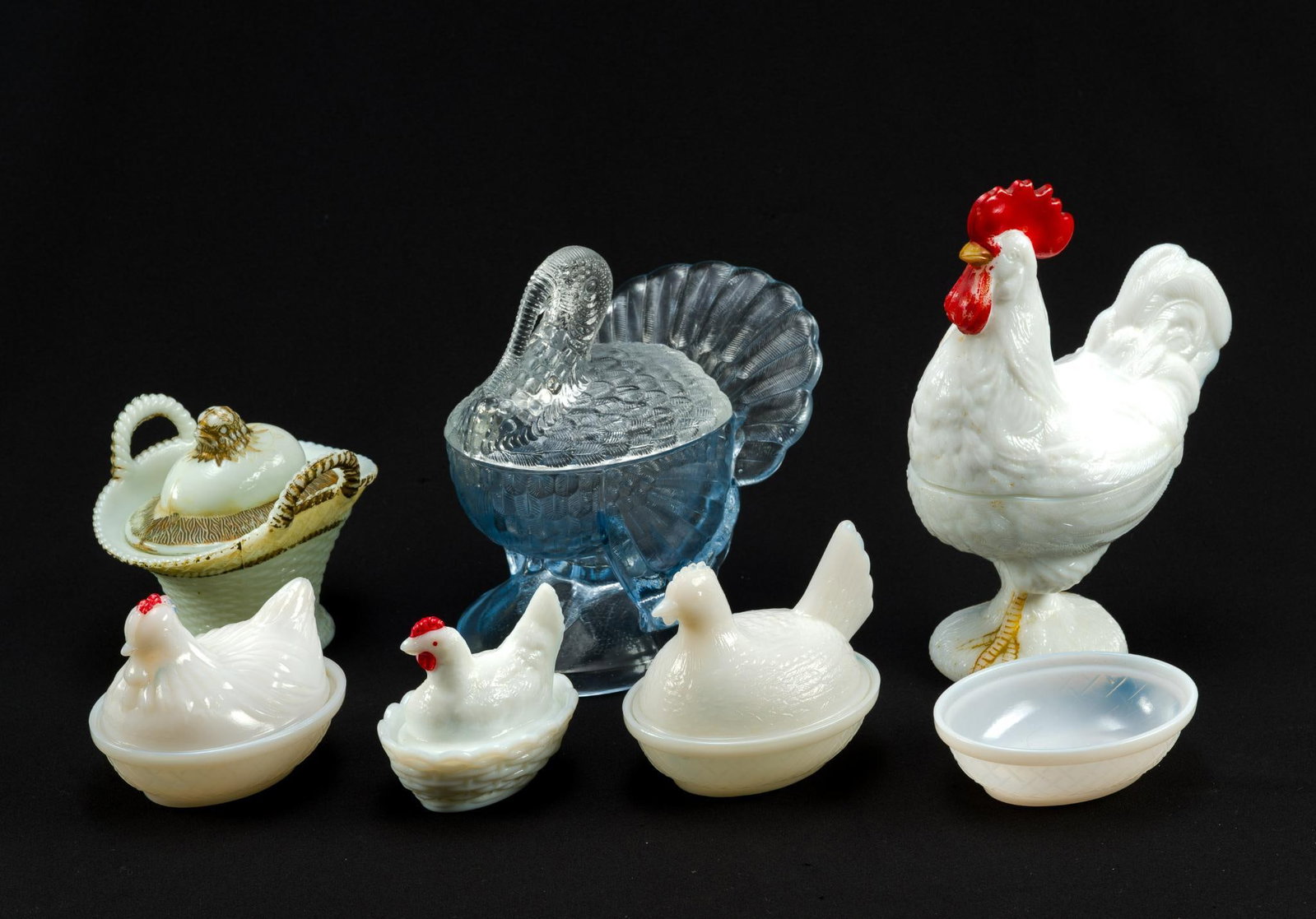 7 Glass Egg, Rooster, and Turkey Containers: Incl Westmoreland milkglass large rooster, 3 milkglass hens on a nest, milkglass chick emerging from an egg in a basket, milkglass nest with no hen on top, turkey glass container. 3-1/2" to 6-3/4".