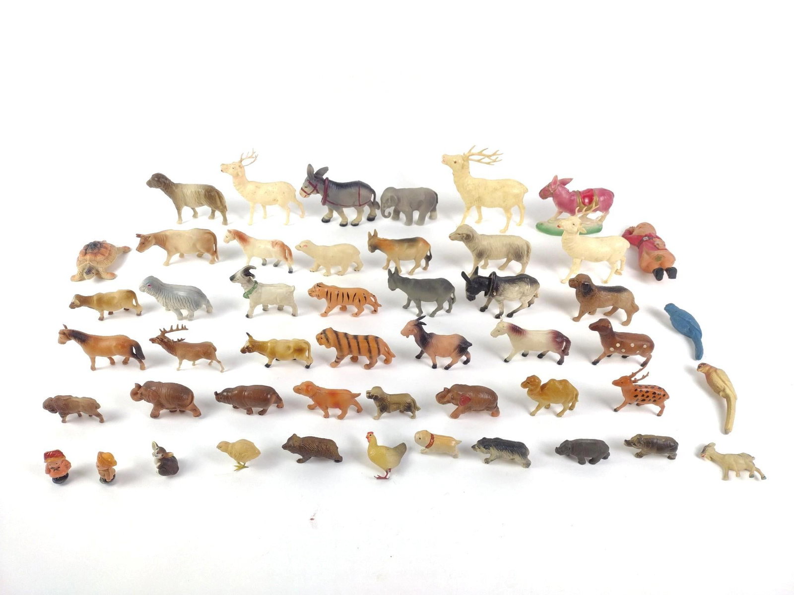 49 Vintage Celluloid Figurines: Includes horses, donkeys, birds, wolves, Santa, reindeer, turtles, 2 people, and more. All experience wear and tear from use but are still in good condition. 1-1/2" to 5-1/4". 